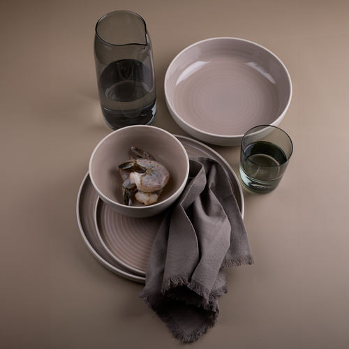 Essential dinnerware, glassware, pitcher, and napkins in Grey tones.