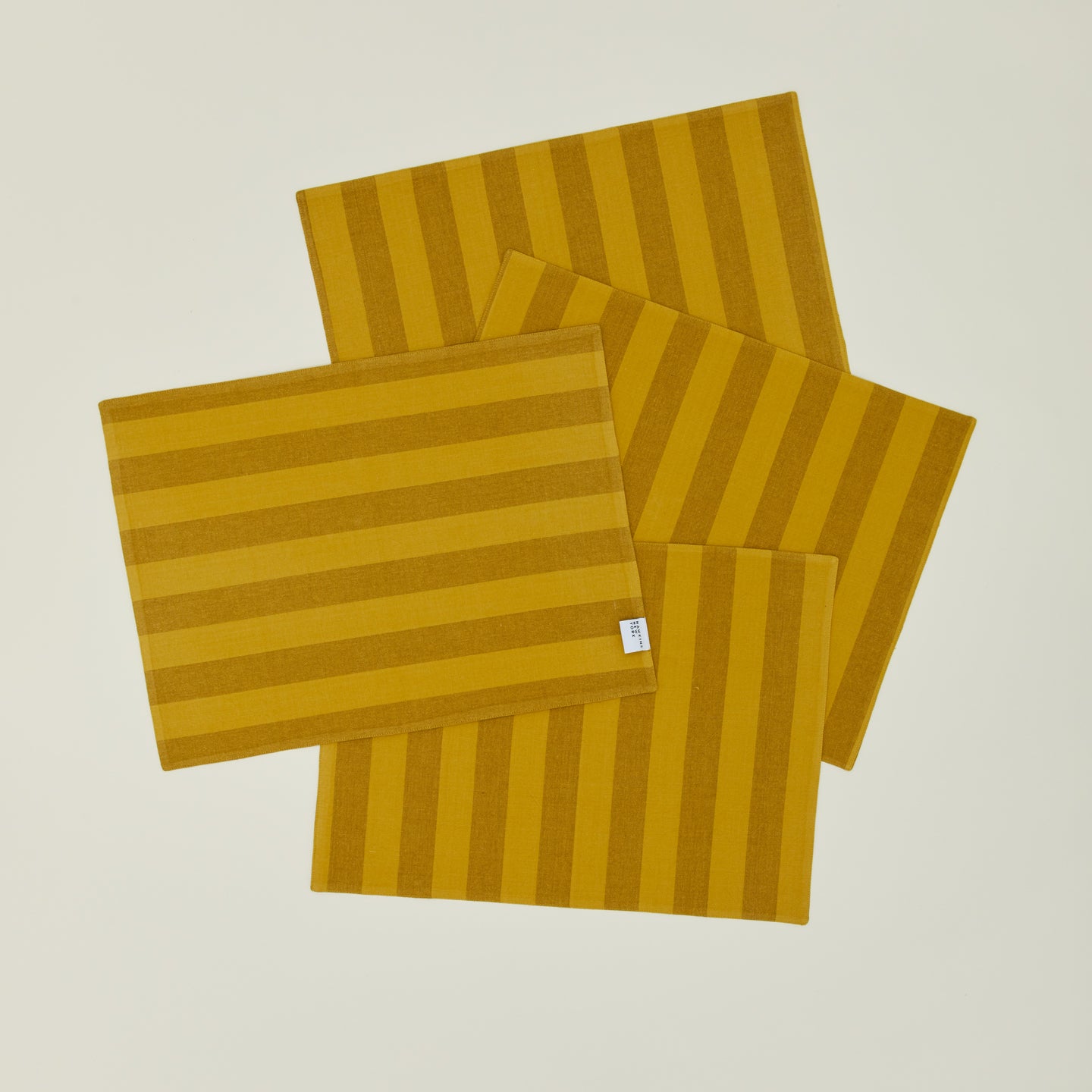 Set of four Essential Striped Placemats in Mustard and Bronze.