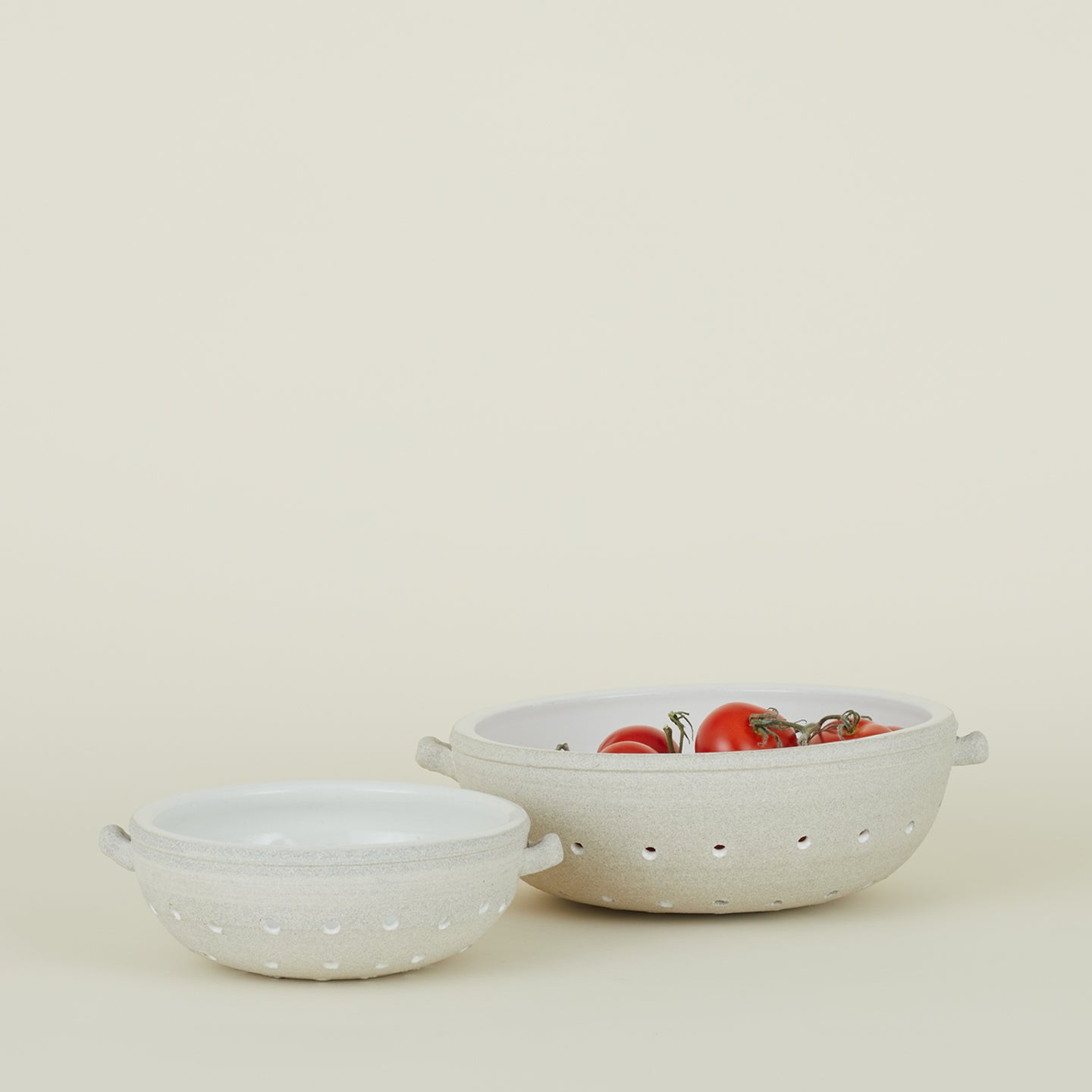 Large and small colander with tomatoes