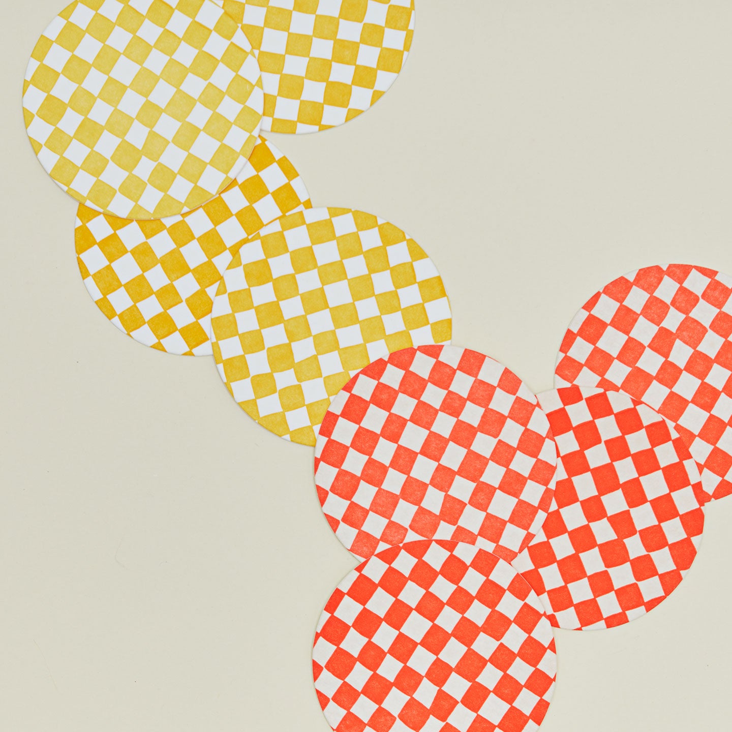 Close up of reusable checkered paper coasters.