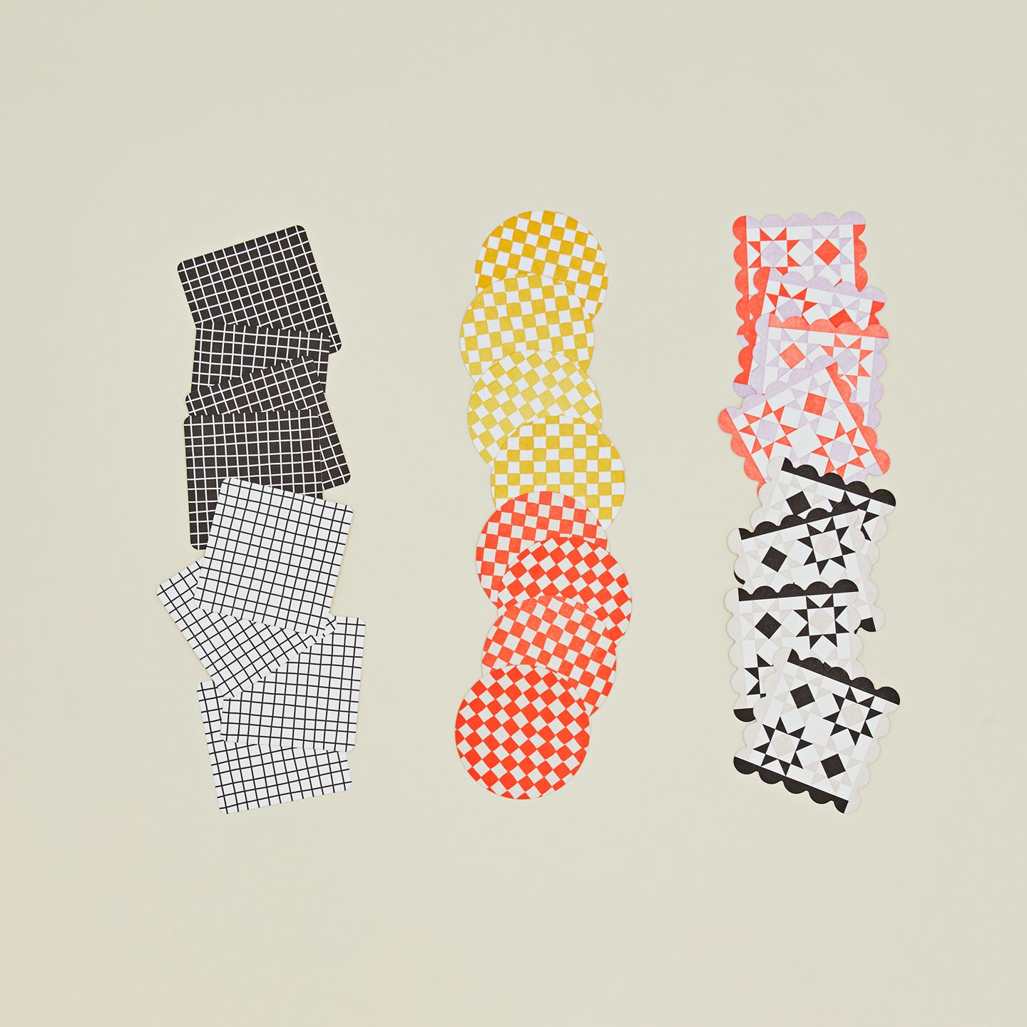Reusable paper coasters in various patterns and colors.