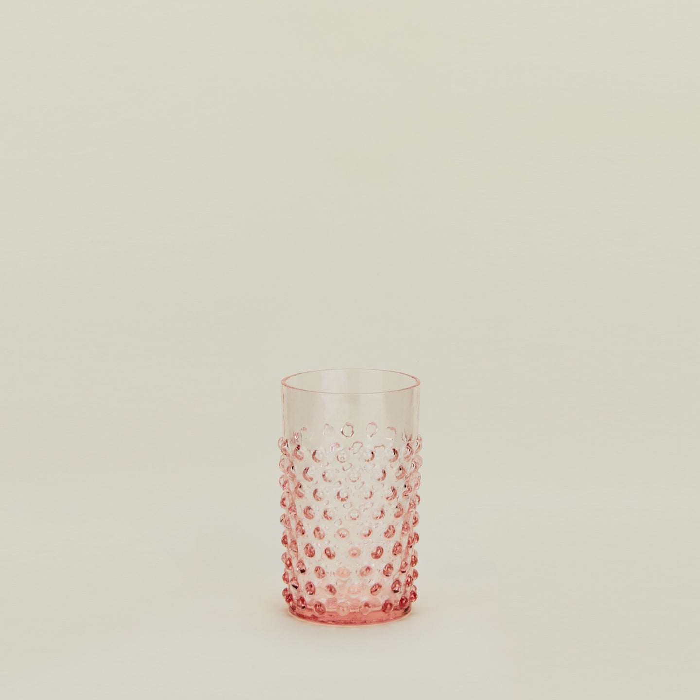 Textured blush glass tumbler.