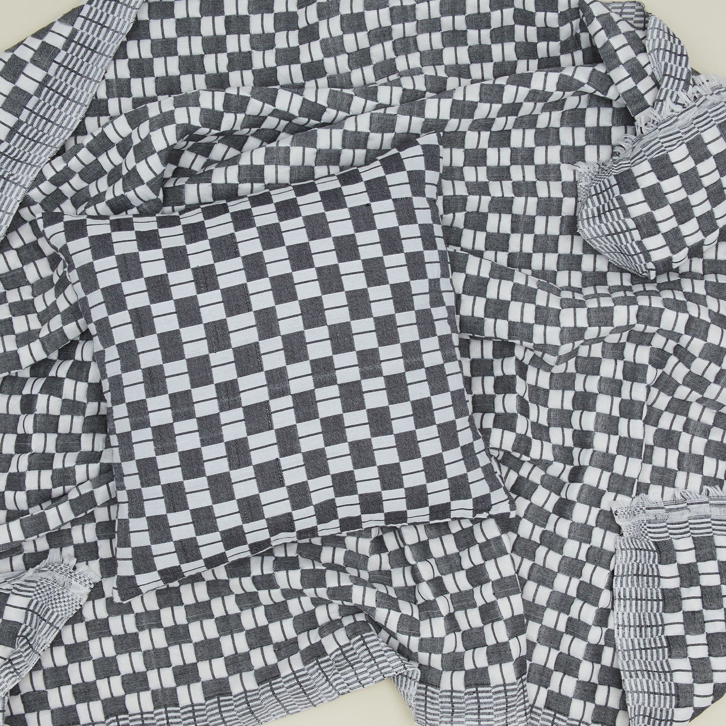 Quilted checkered pillow and throw in black and white.