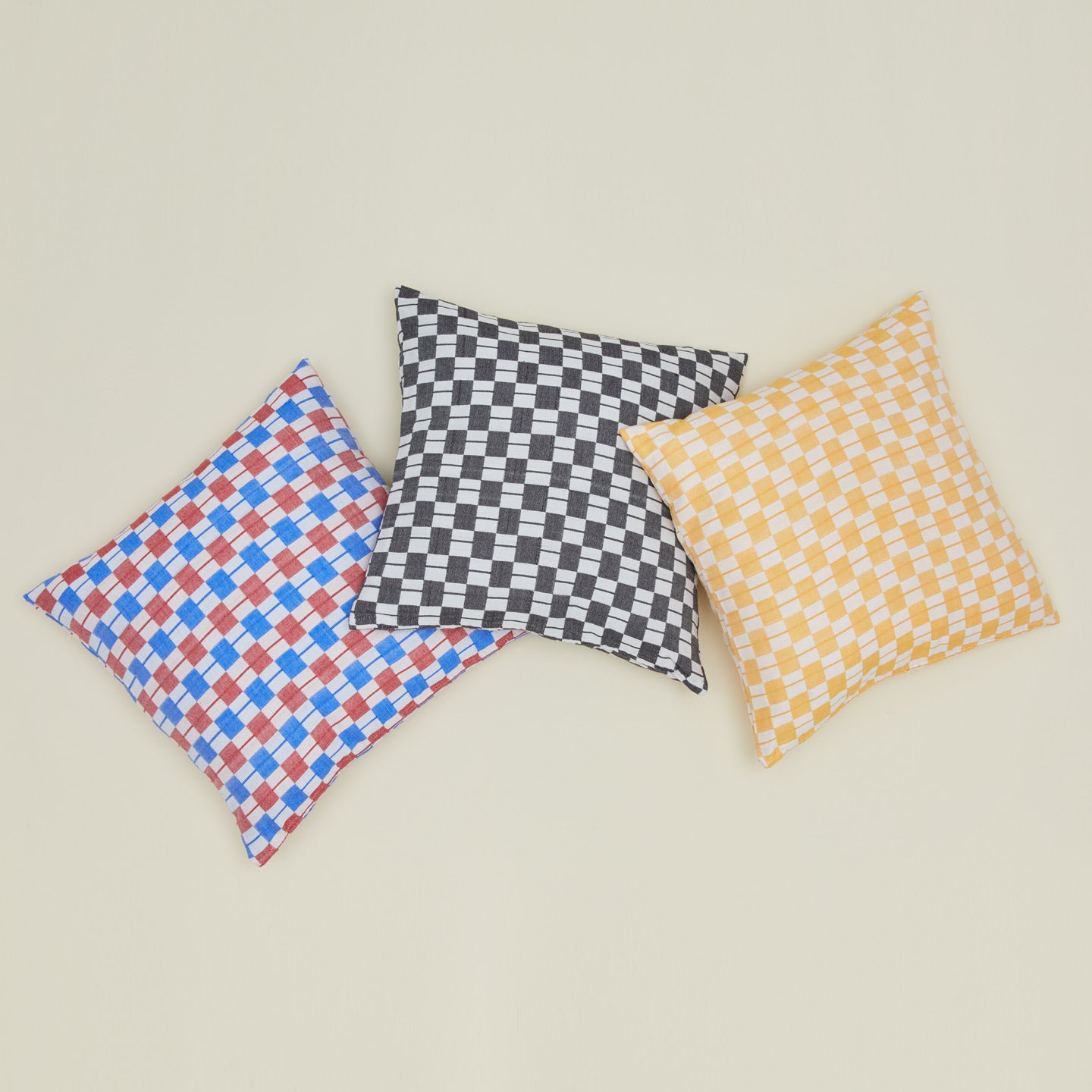 Quilted checkered pillows in various colors.