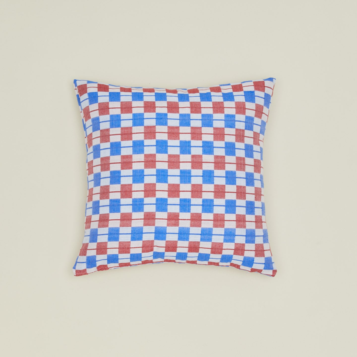 Quilted checkered pillow in red and blue.