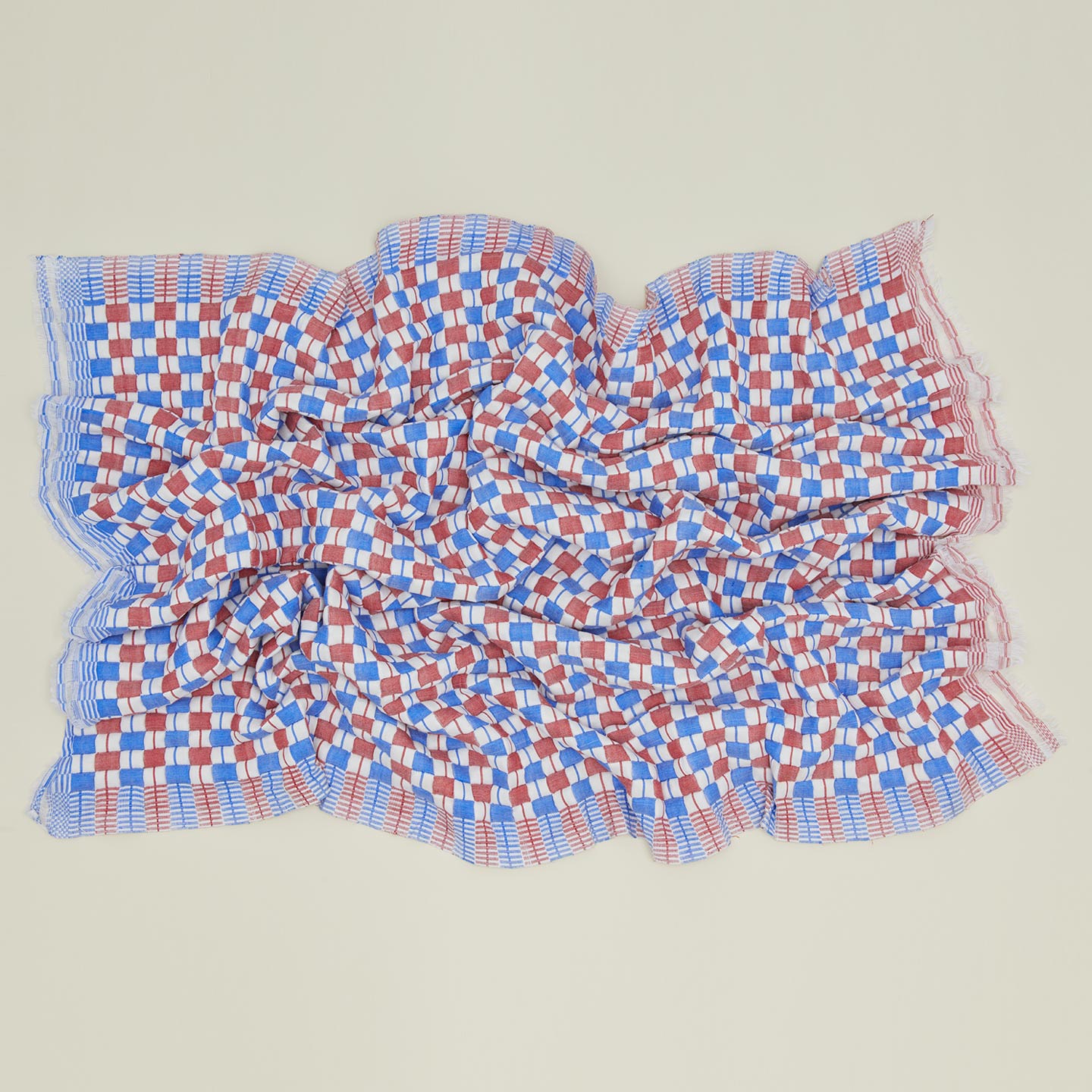Quilted checkered throw in red and blue, open.