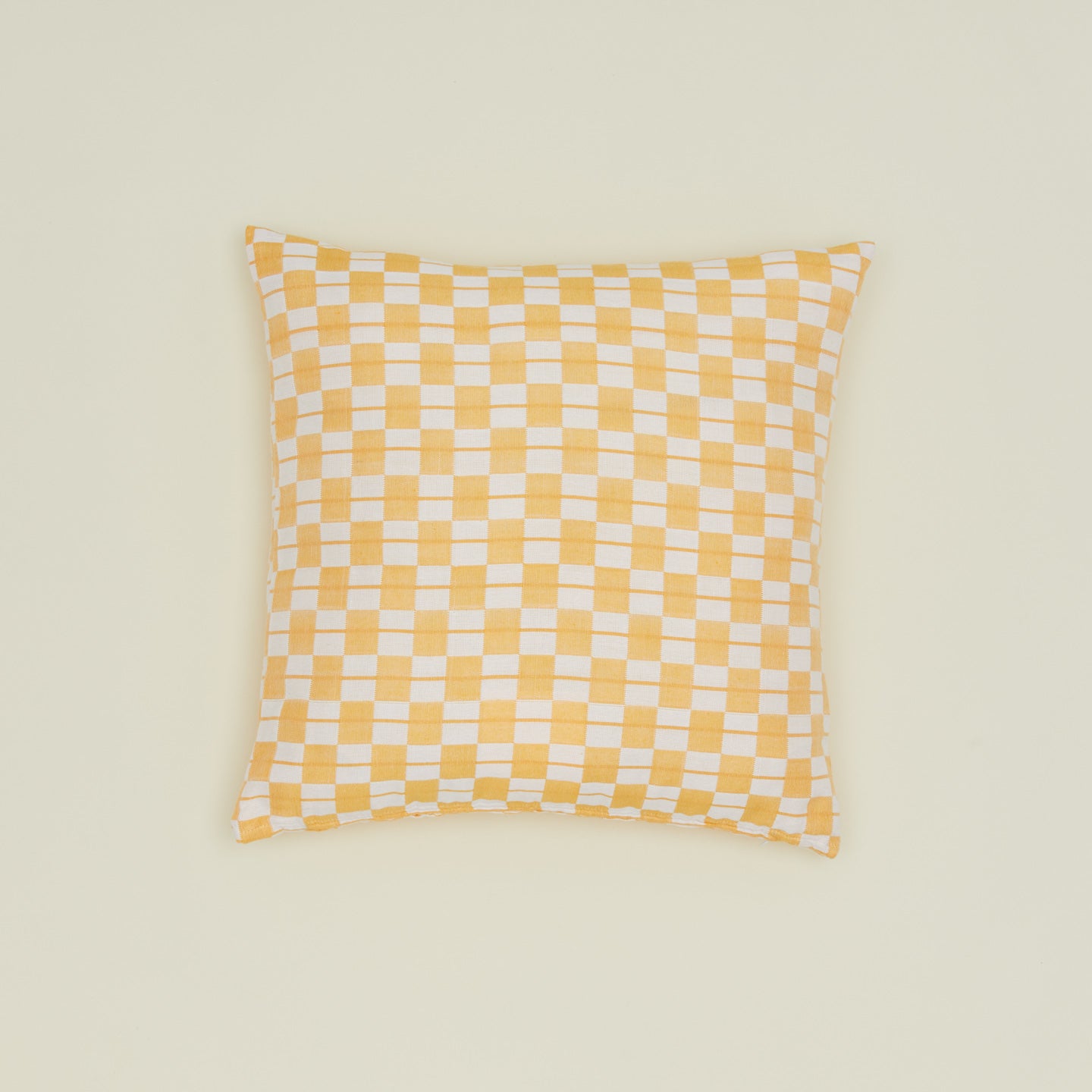 Quilted checkered pillow in yellow and white.