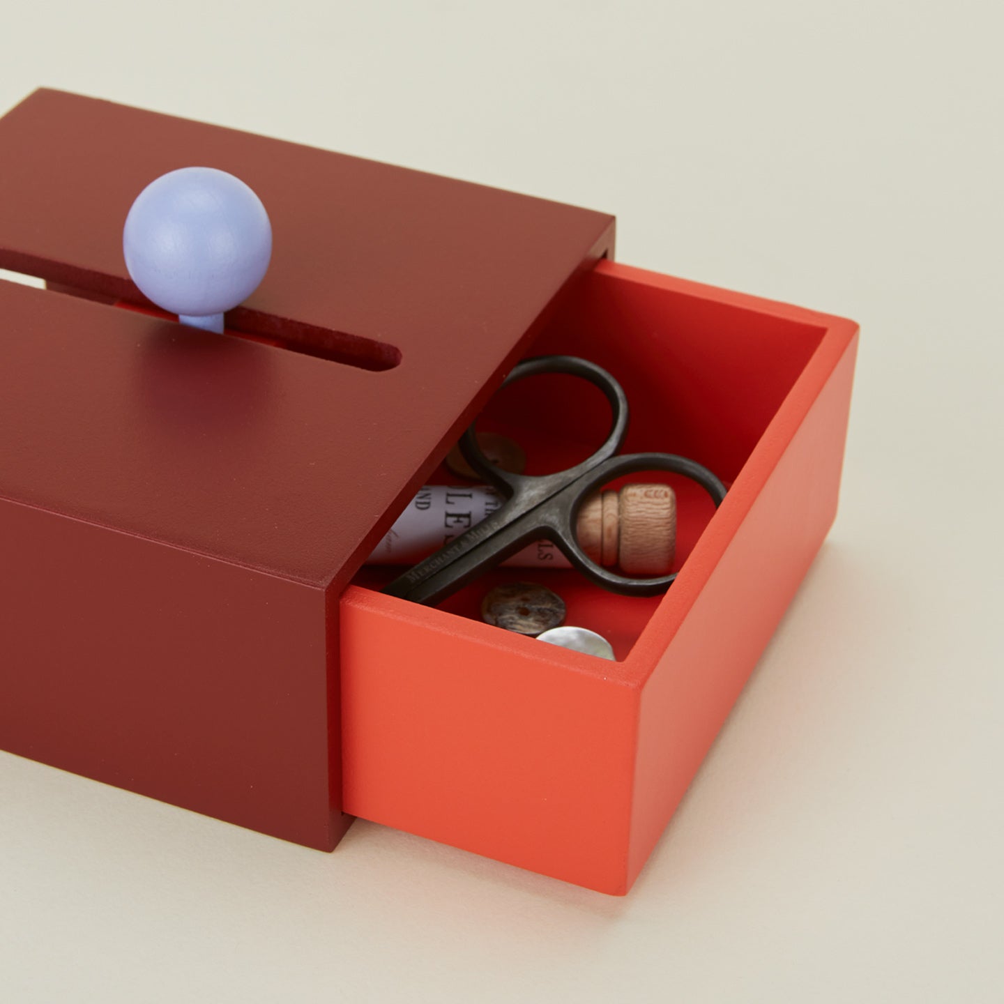 Close up view of Cache box in red with sewing notions