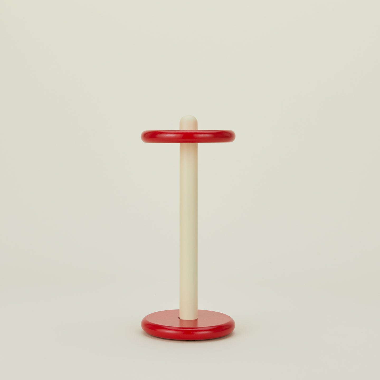 A red and yellow paper towel holder.
