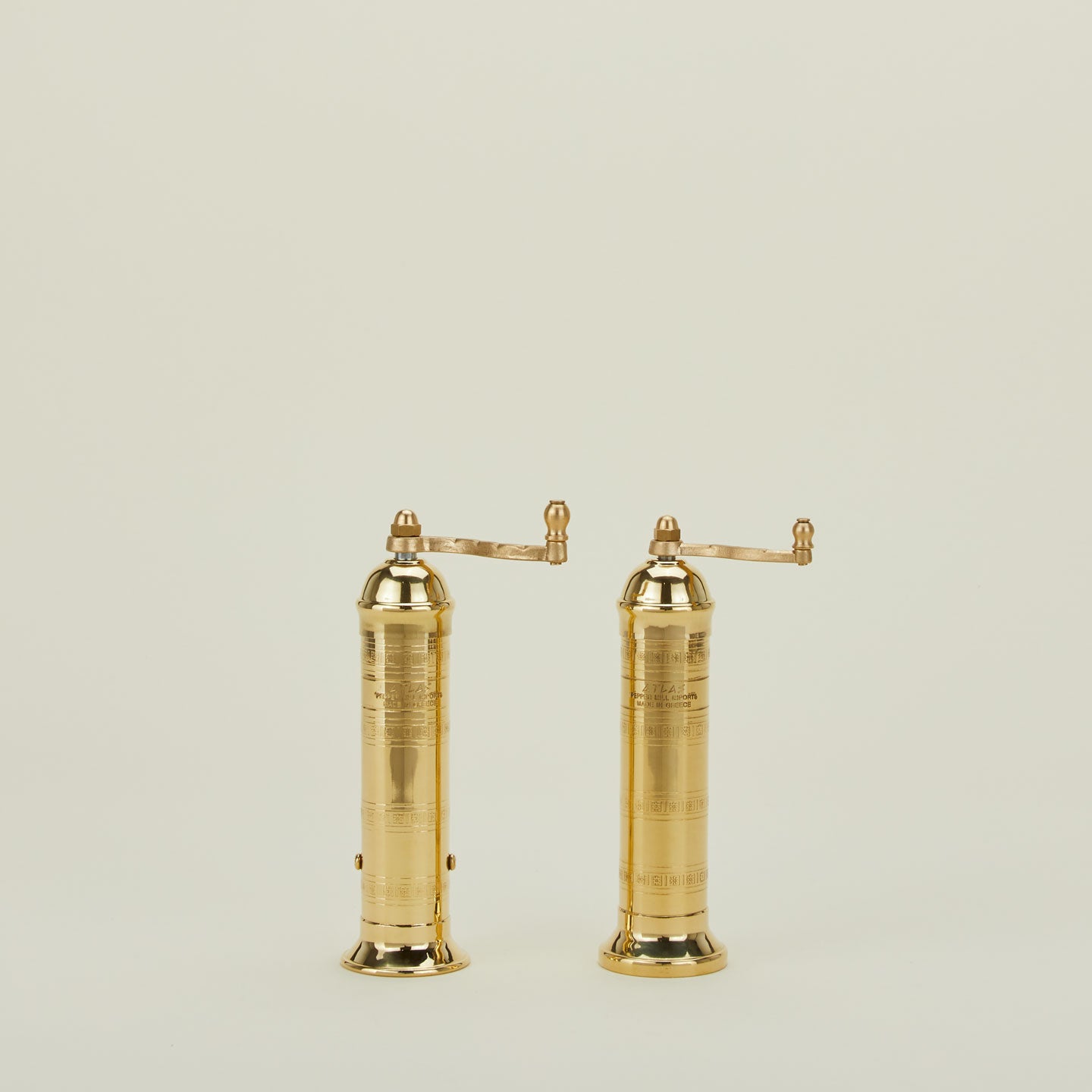 A pair of brass salt and pepper mills.