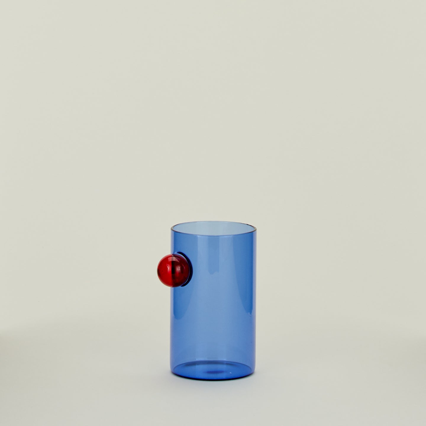 Blue glass with red bubble decoration.
