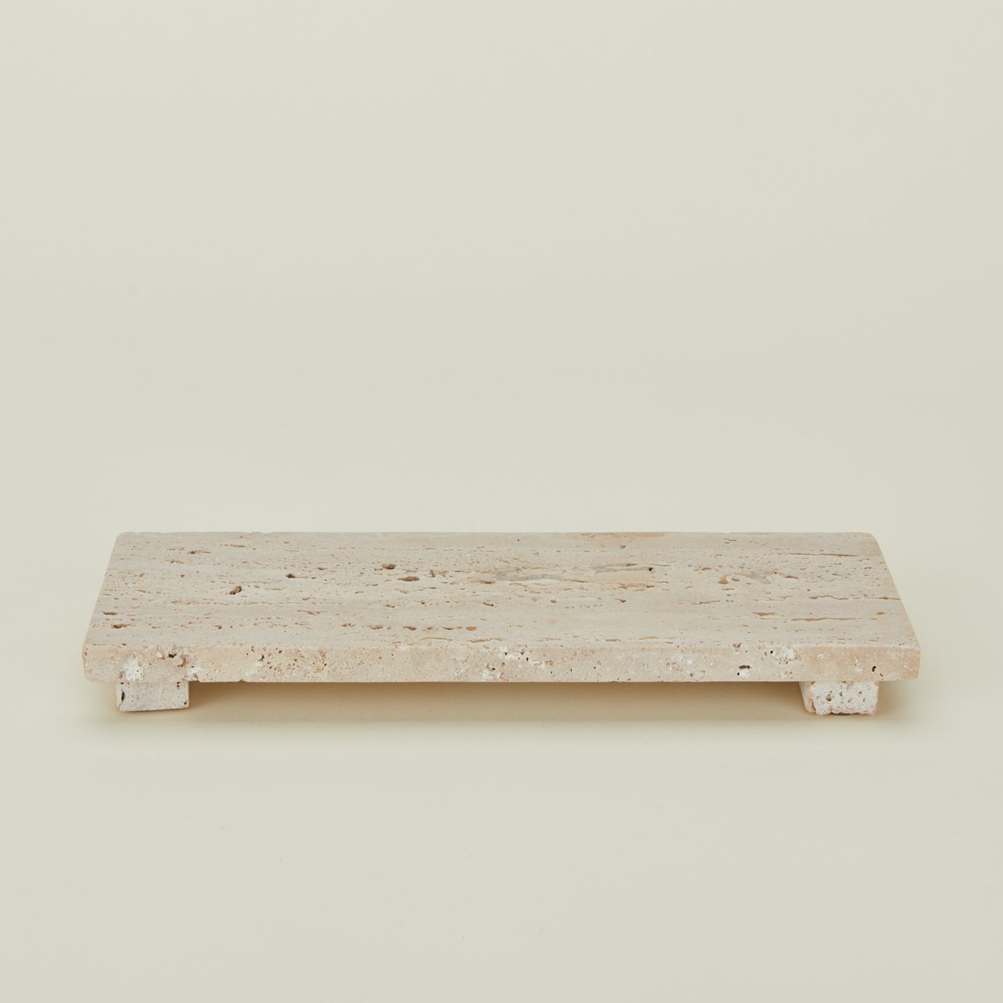 Detailed view of travertine footed serving board