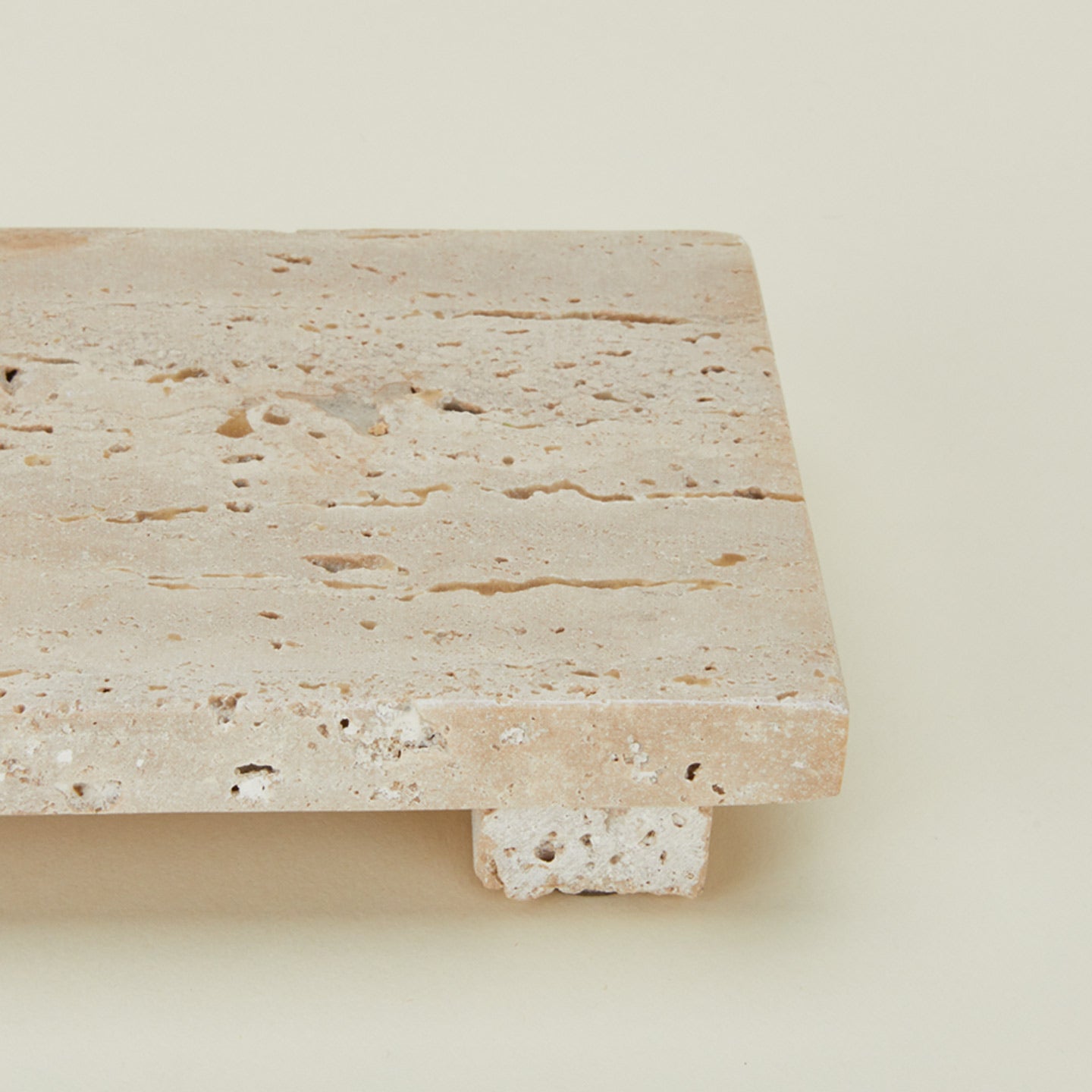 Close up view of travertine footed serving board