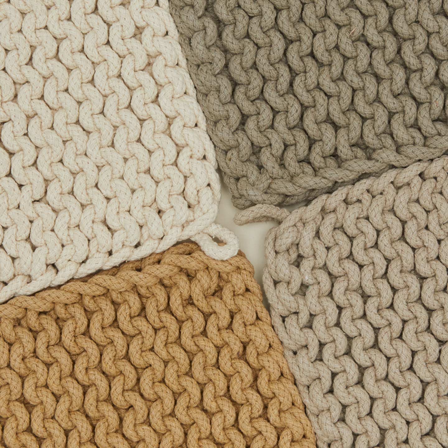 Close up view of crocheted pot holders in natural colors