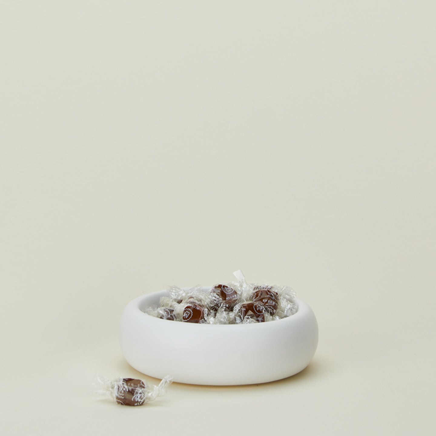 Concave ceramic bowl in white with candy