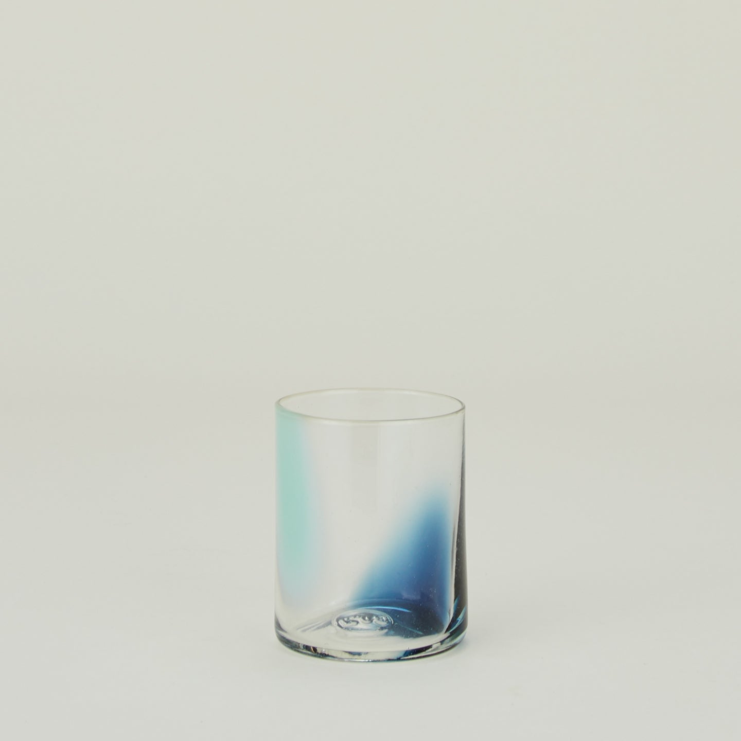 Blown Glass Tumbler with sky and peacock swirl pattern.