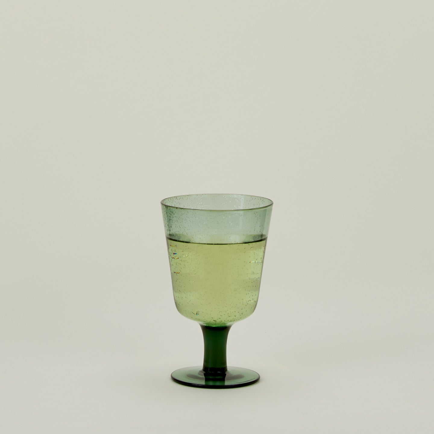 Stemmed Wine Glass in Jade, filled with water.
