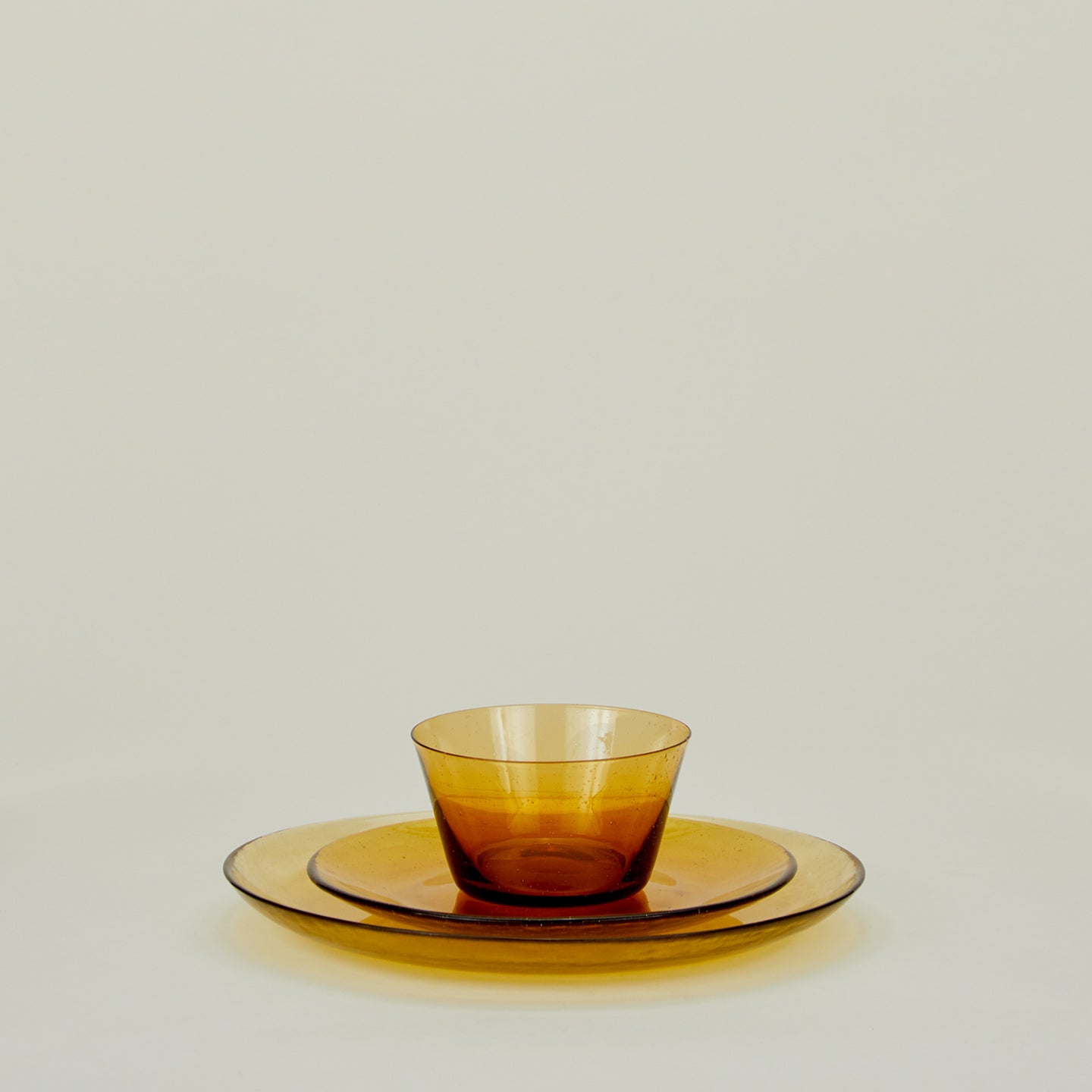 Group of Amber glass dinner plate, salad plate and bowl.