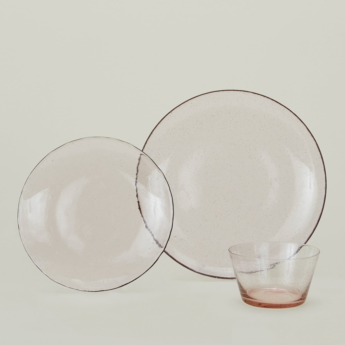Group of Blush glass dinner plate, dinner plate and bowl.