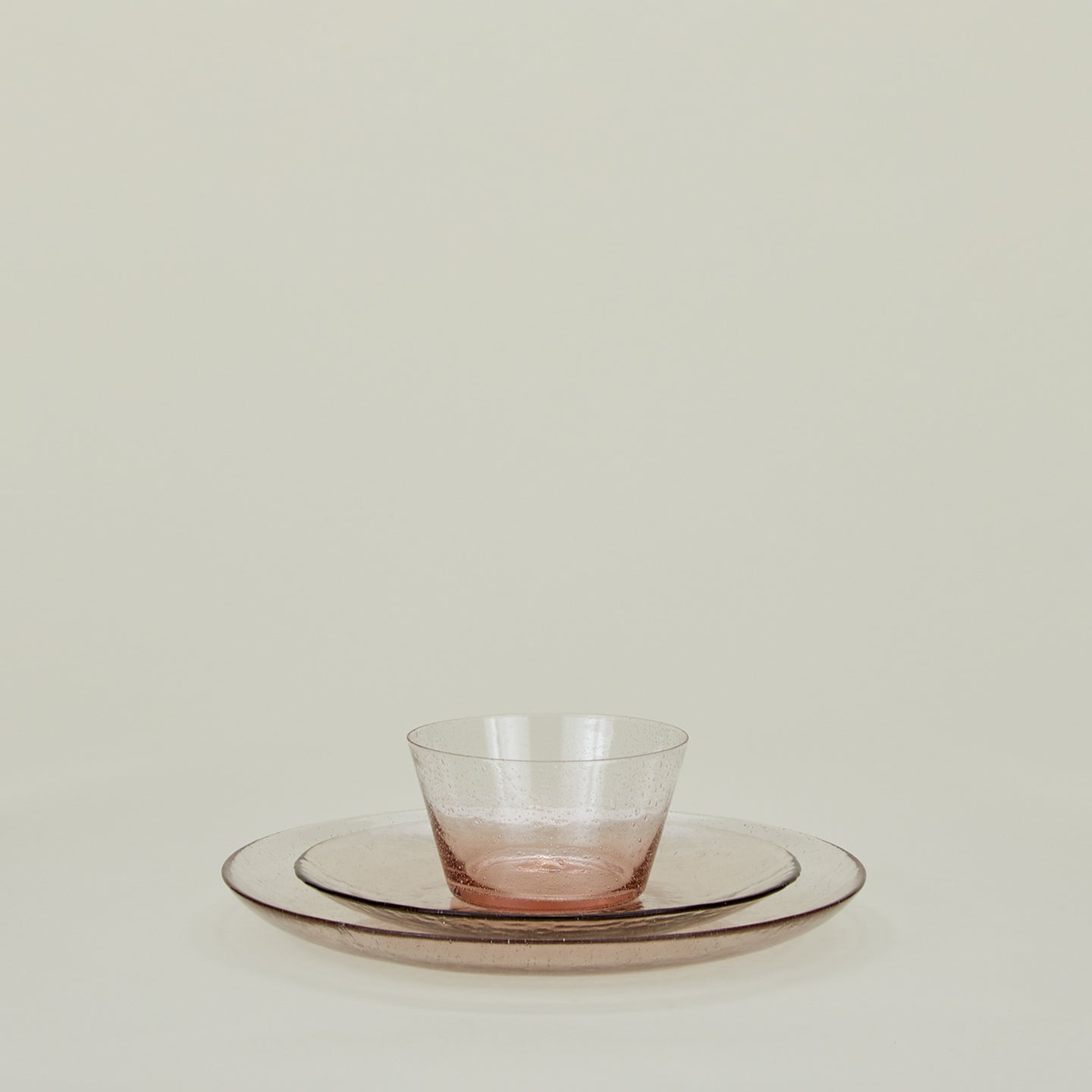 Group of Blush glass dinner plate, salad plate and bowl.