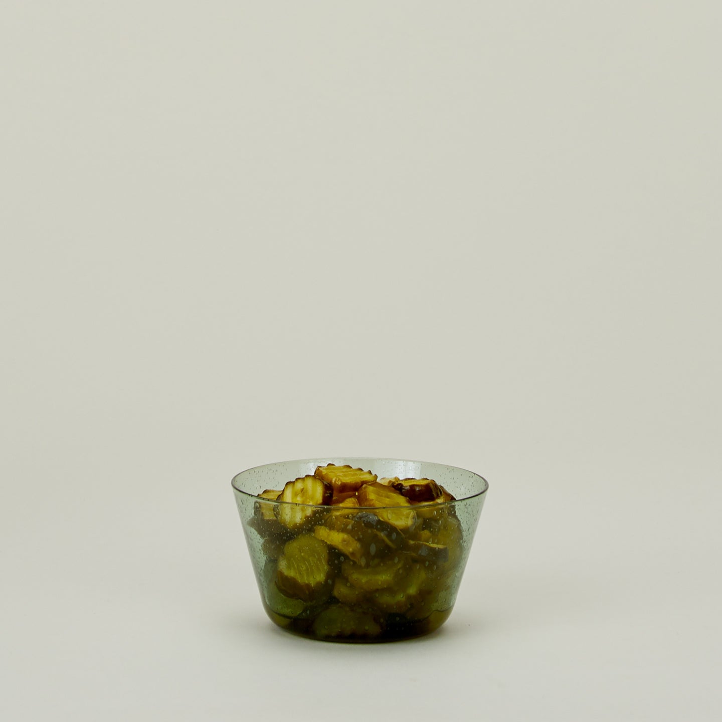 Glass Bowl in Jade, filled with pickles.