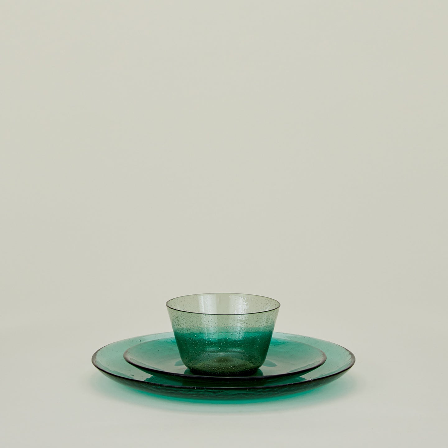 Group of Jade glass salad plate, dinner plate and bowl, stacked.