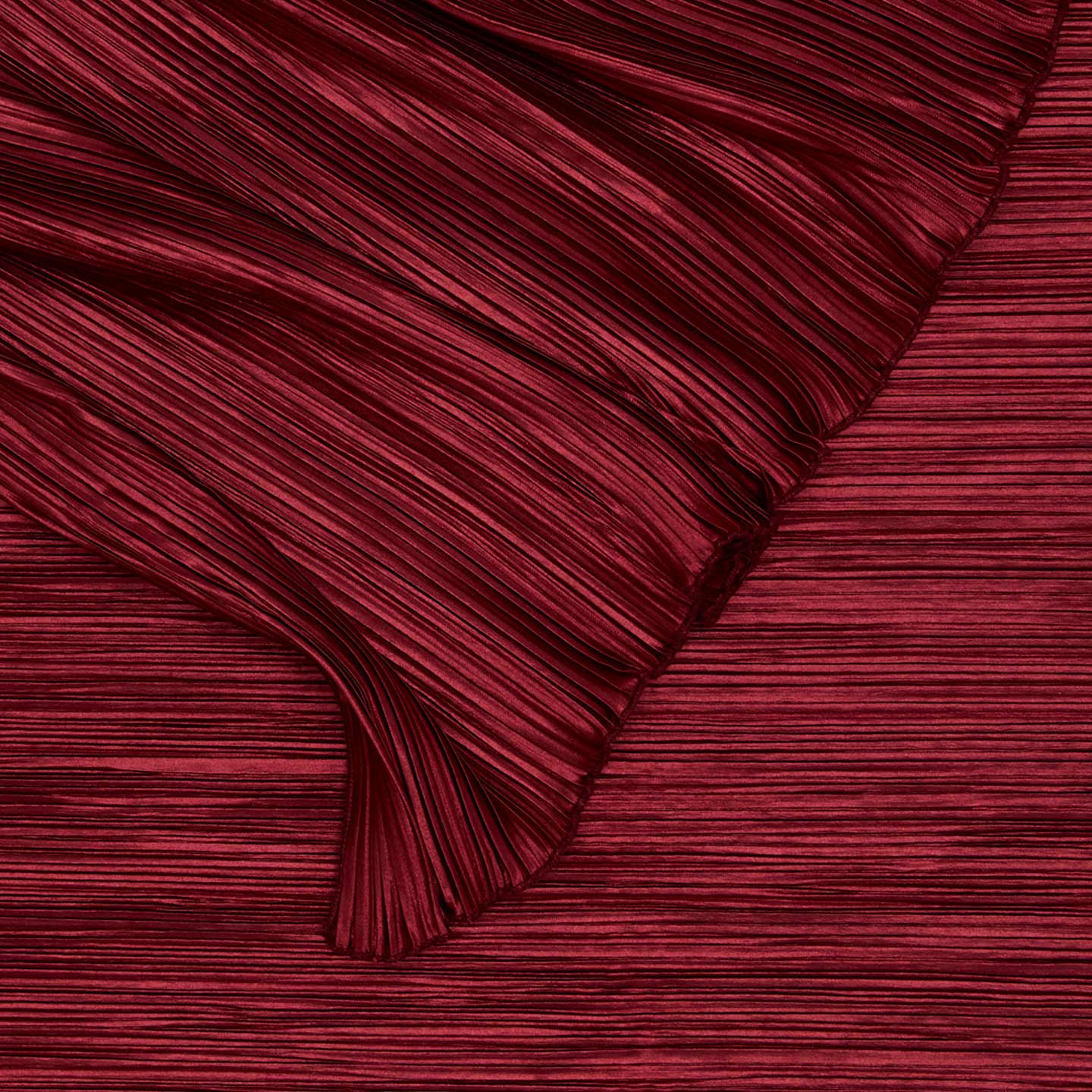 Close up view of Cahaya pleated tablecloth in red.