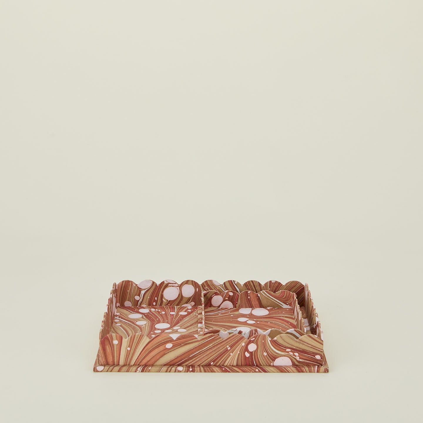 Set of two nested scalloped marbled trays in mocha.