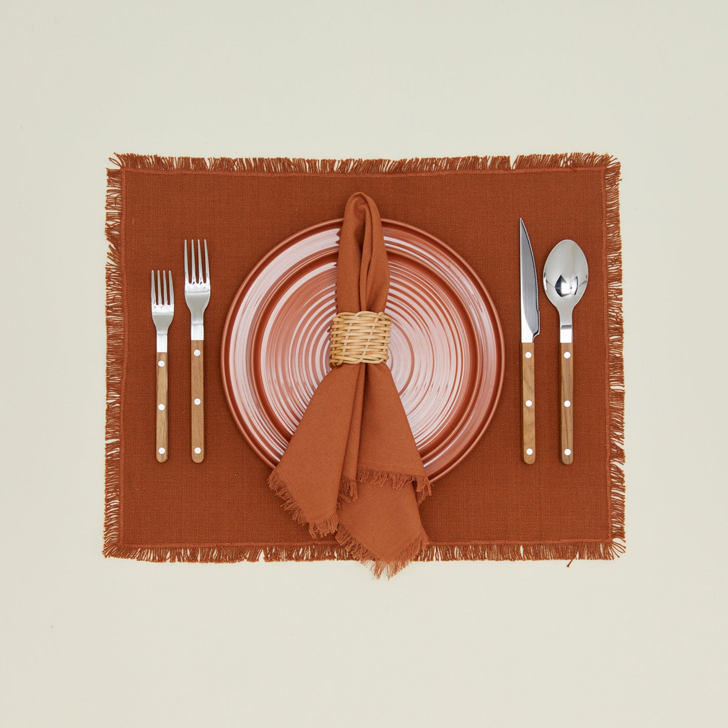 Basket weave napkin rings with terracotta plate, cutlery and, terracotta placement