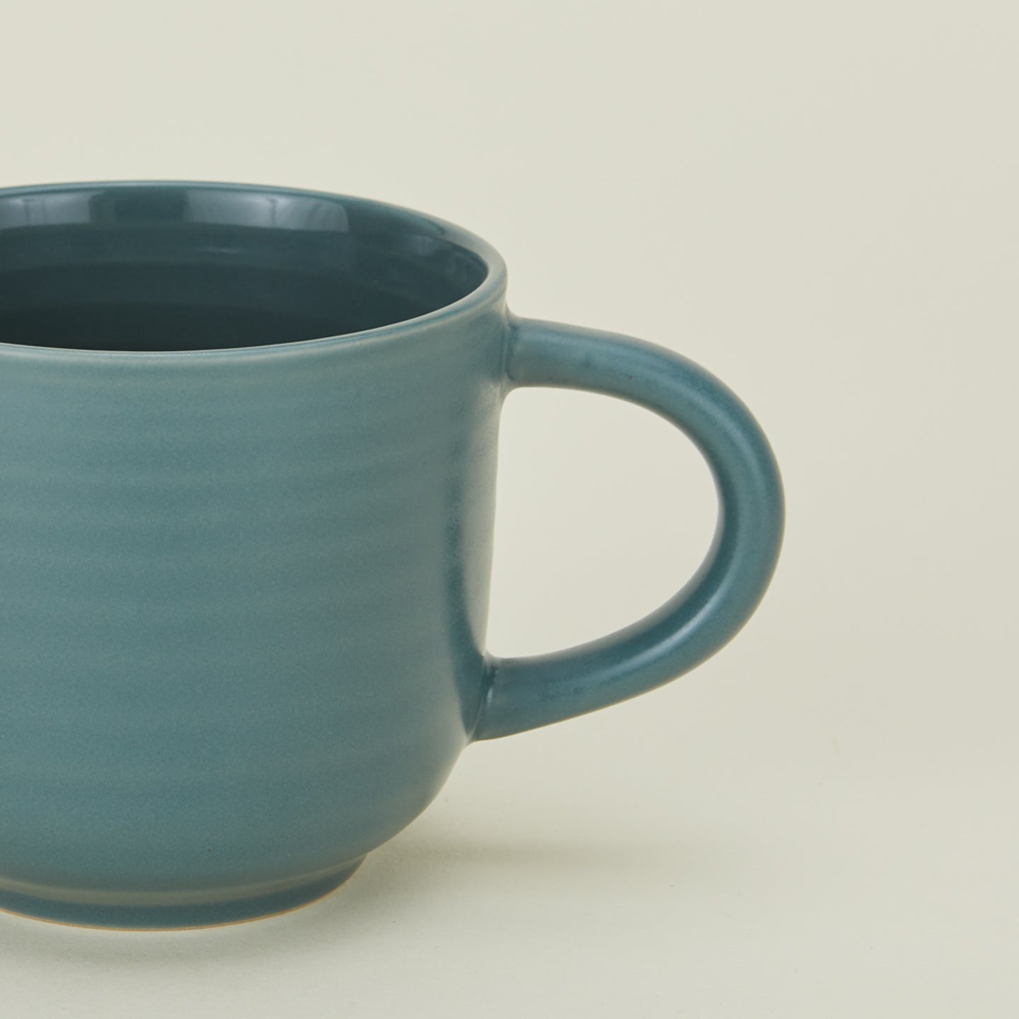 Close up view of essential dinnerware mug in peacock