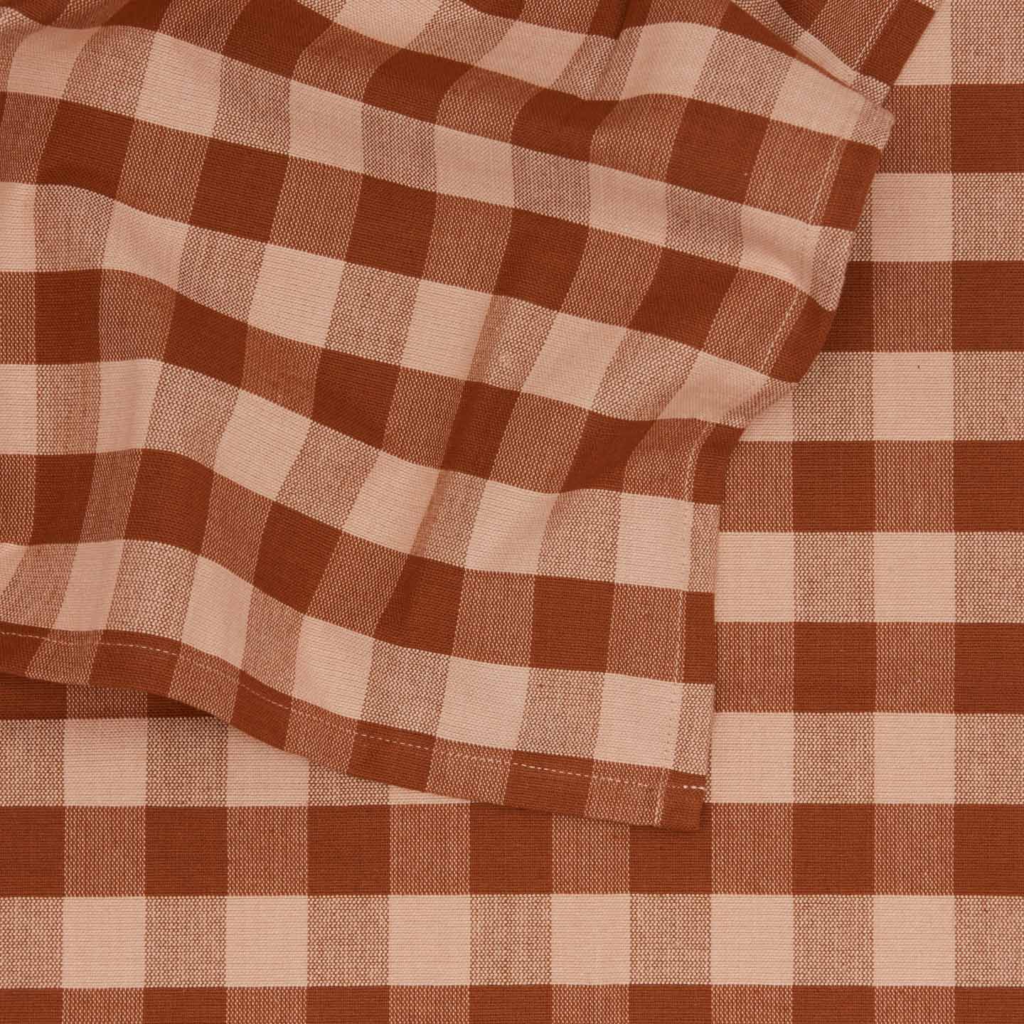 Close up view of Essential Gingham tablecloth in blush/terracotta