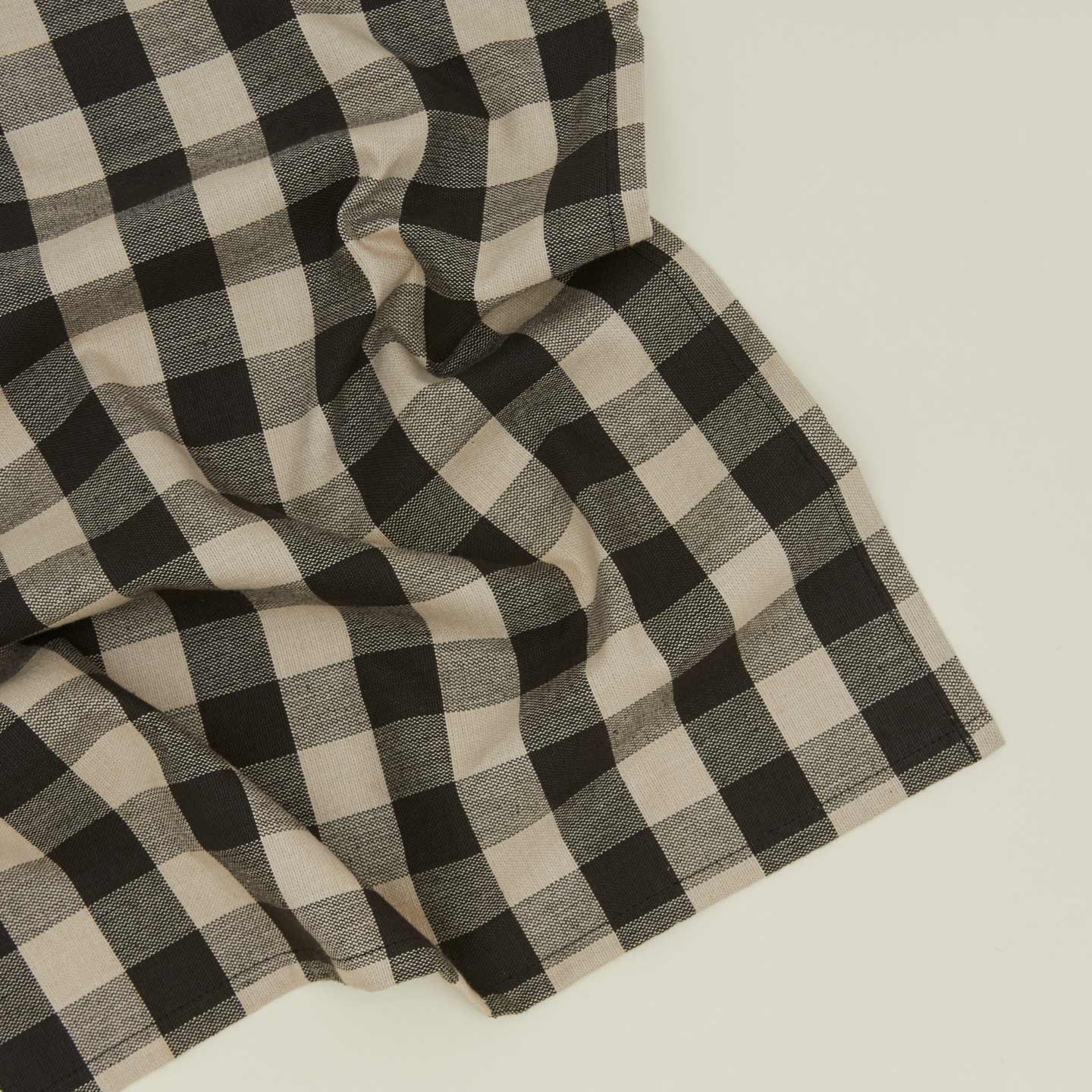 Close up view of Essential Gingham napkin in black/grey