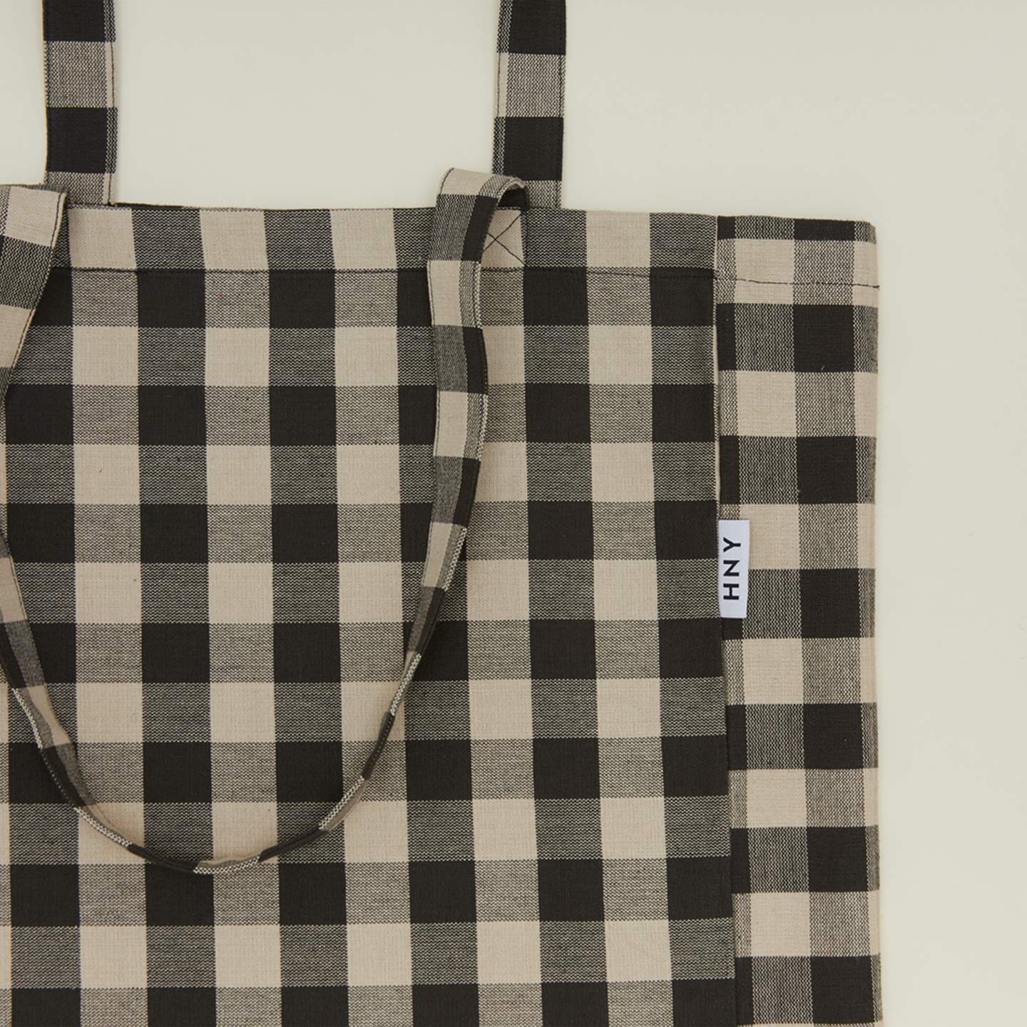 Close up view of gingham tote in grey/black