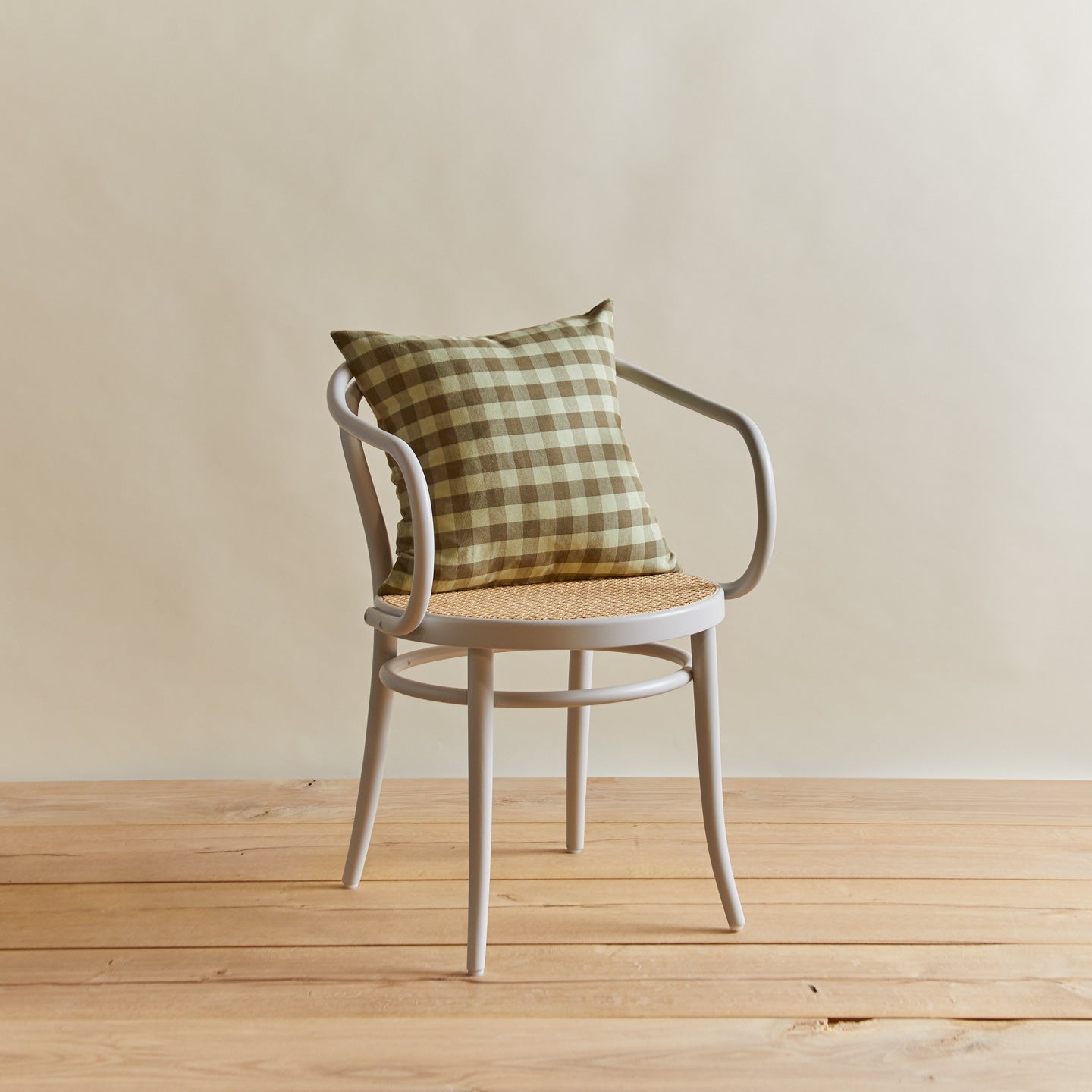 Essential gingham pillow in sage/olive on chair