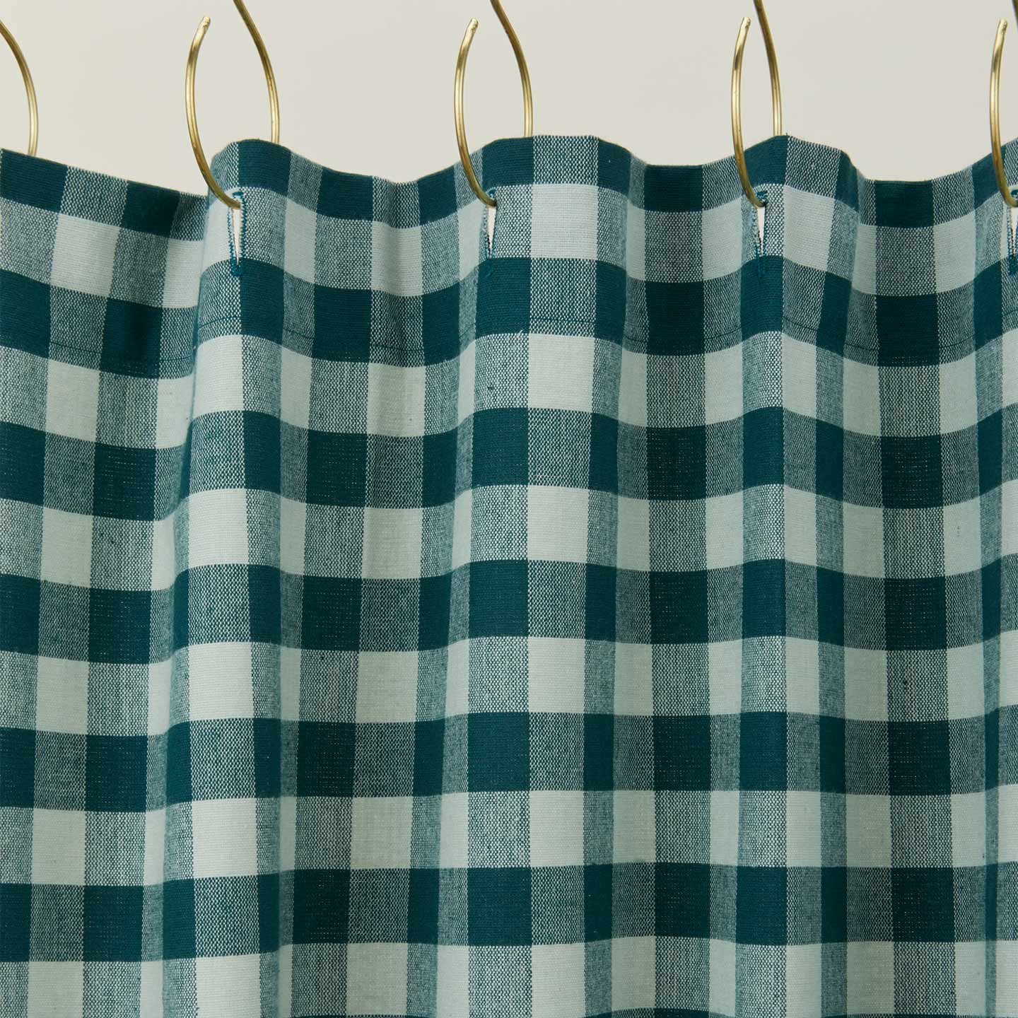 Gingham shower curtain in sky/peacock on gold curtain hooks