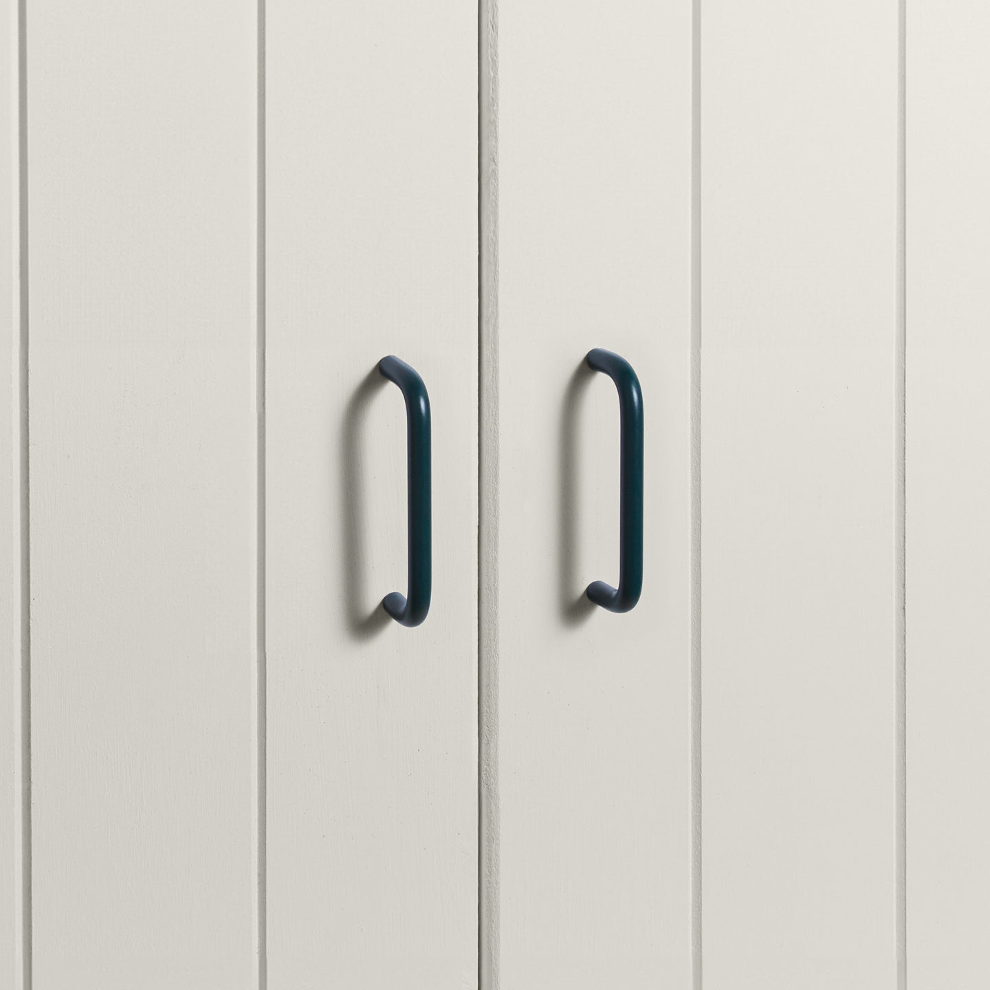 Small peacock pulls on white doors