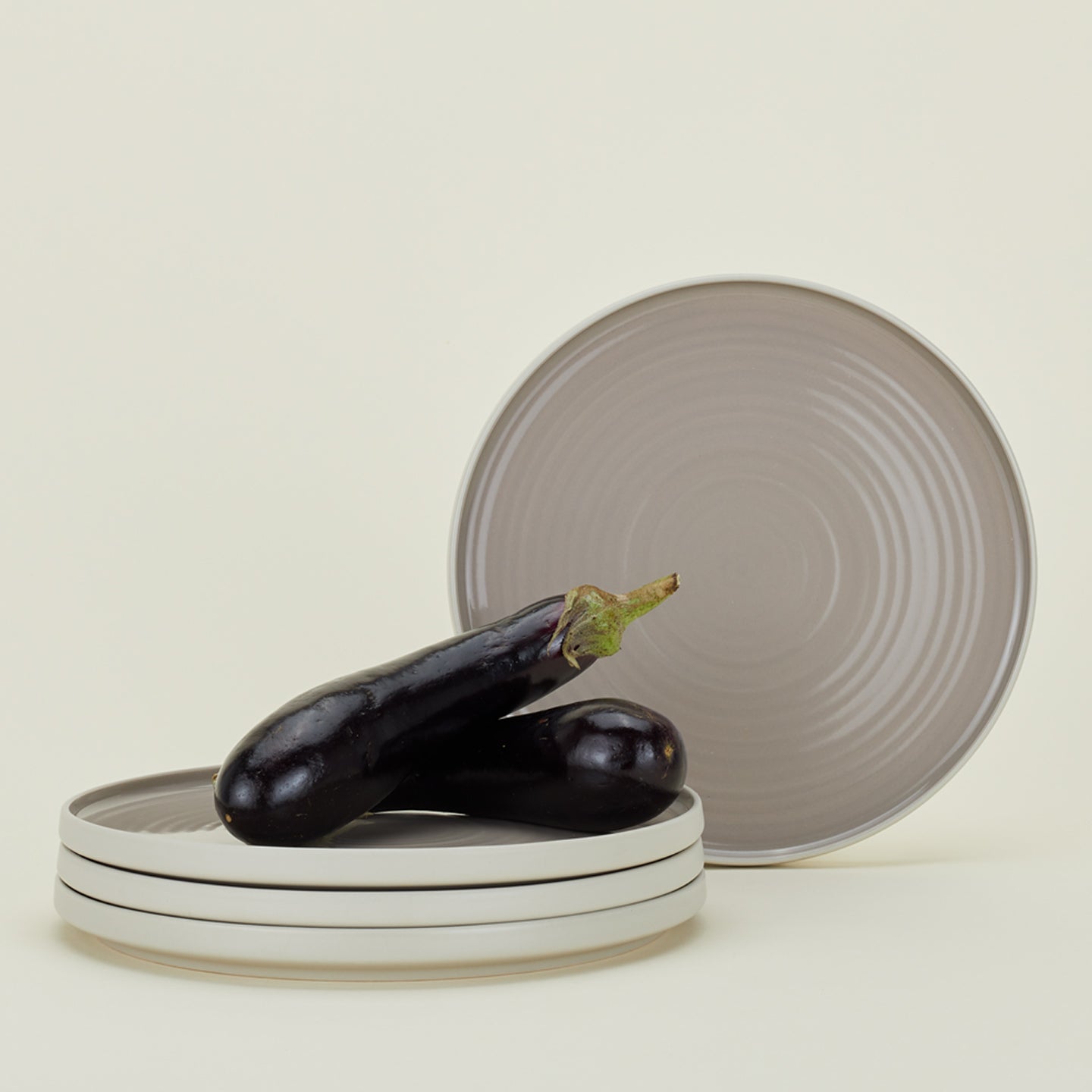 Four Essential Dinner Plates in Light Grey, with eggplant.