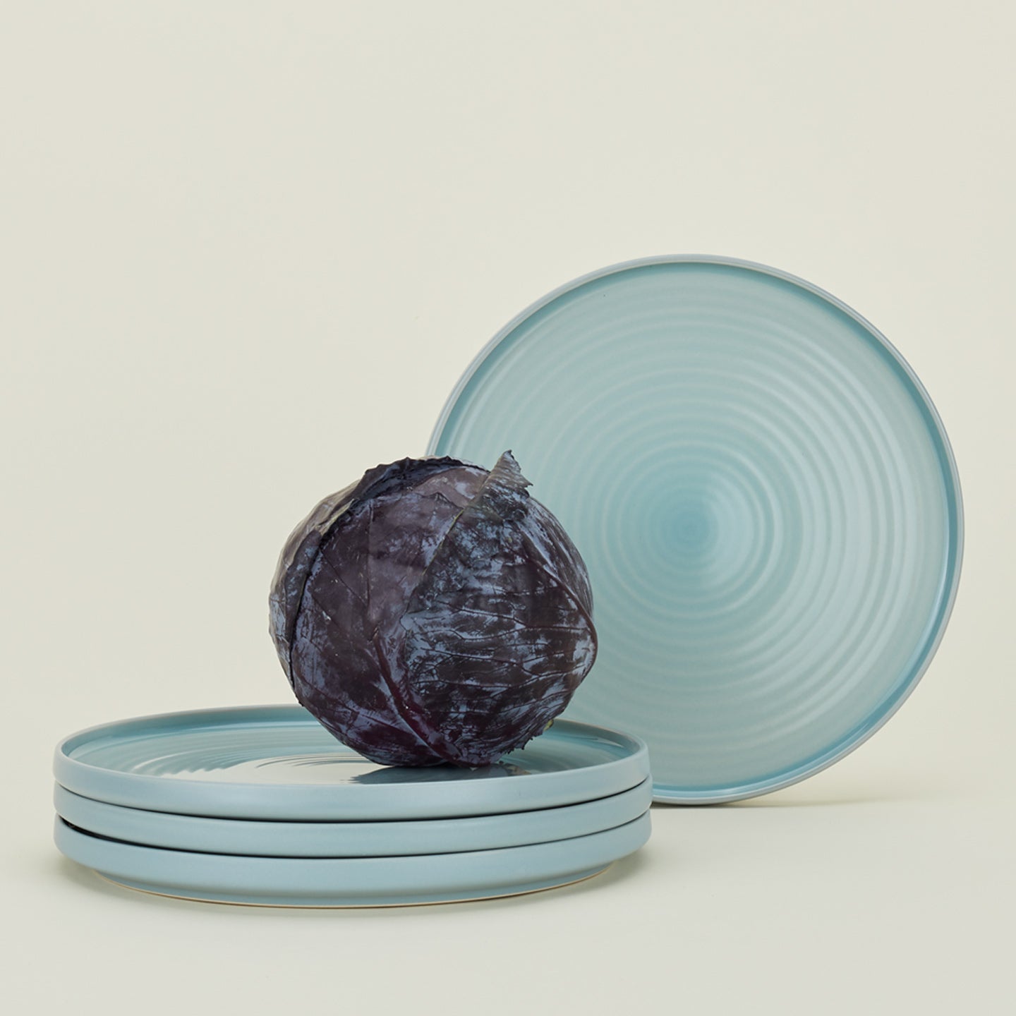 Four Essential Dinner Plates in Sky, with cabbage.