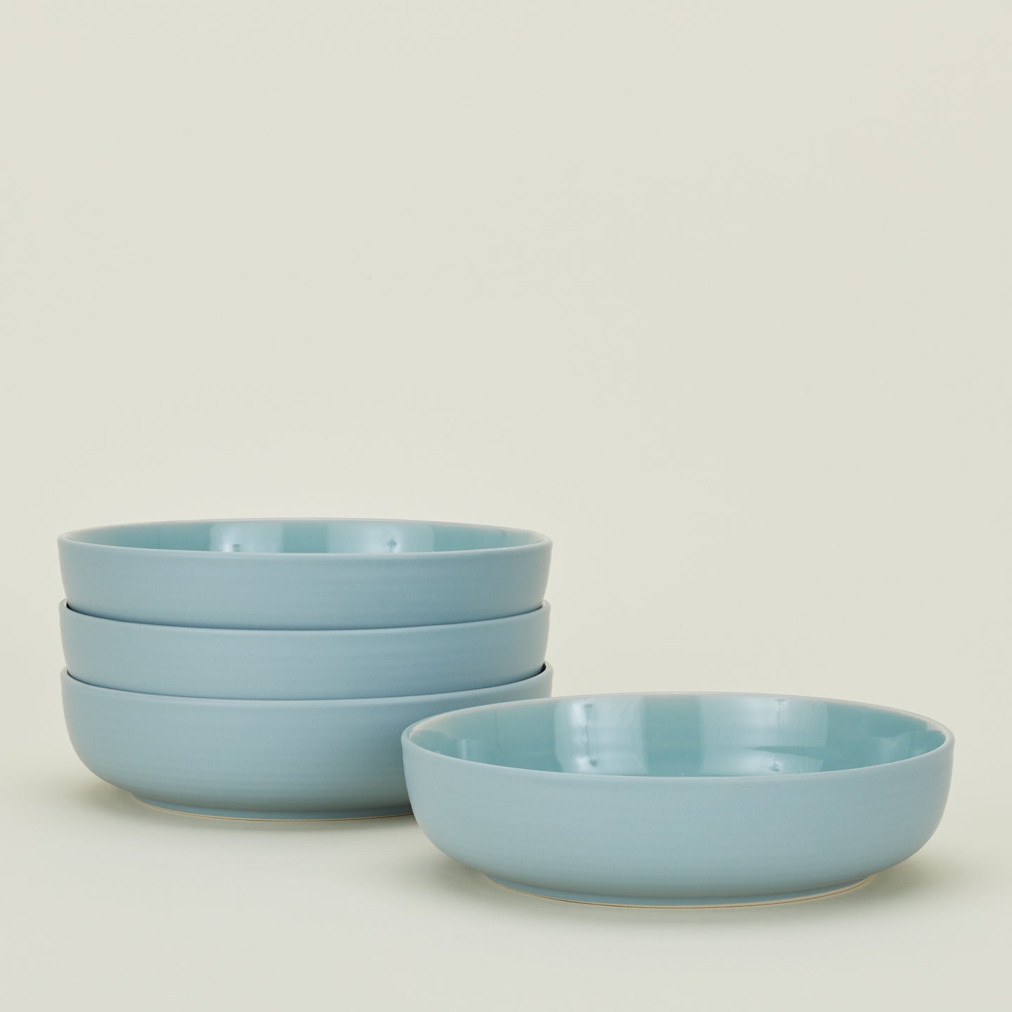 Four sky blue Essential Low Bowls.