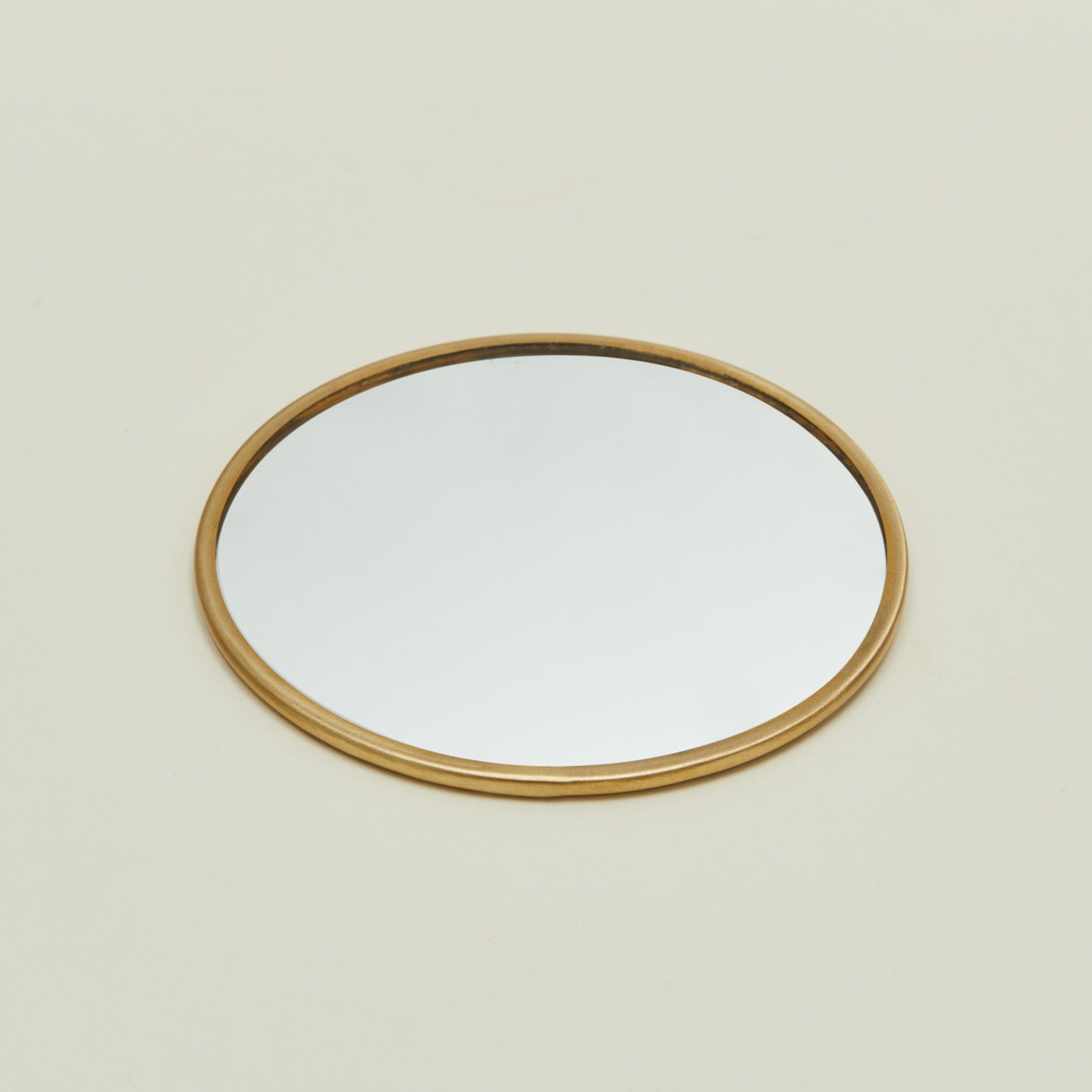 Detailed view of round brass mirror