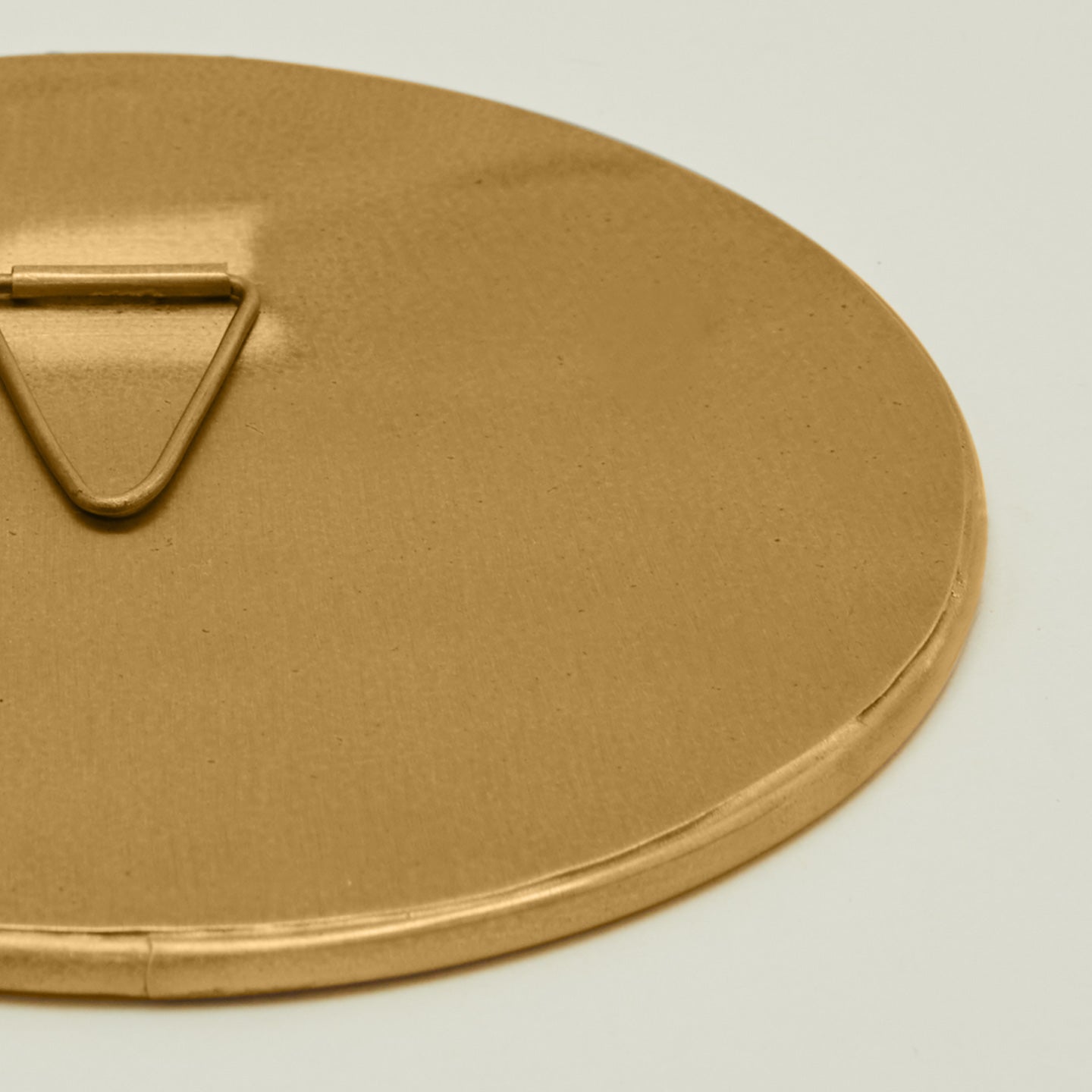 Close up view of round brass mirror.