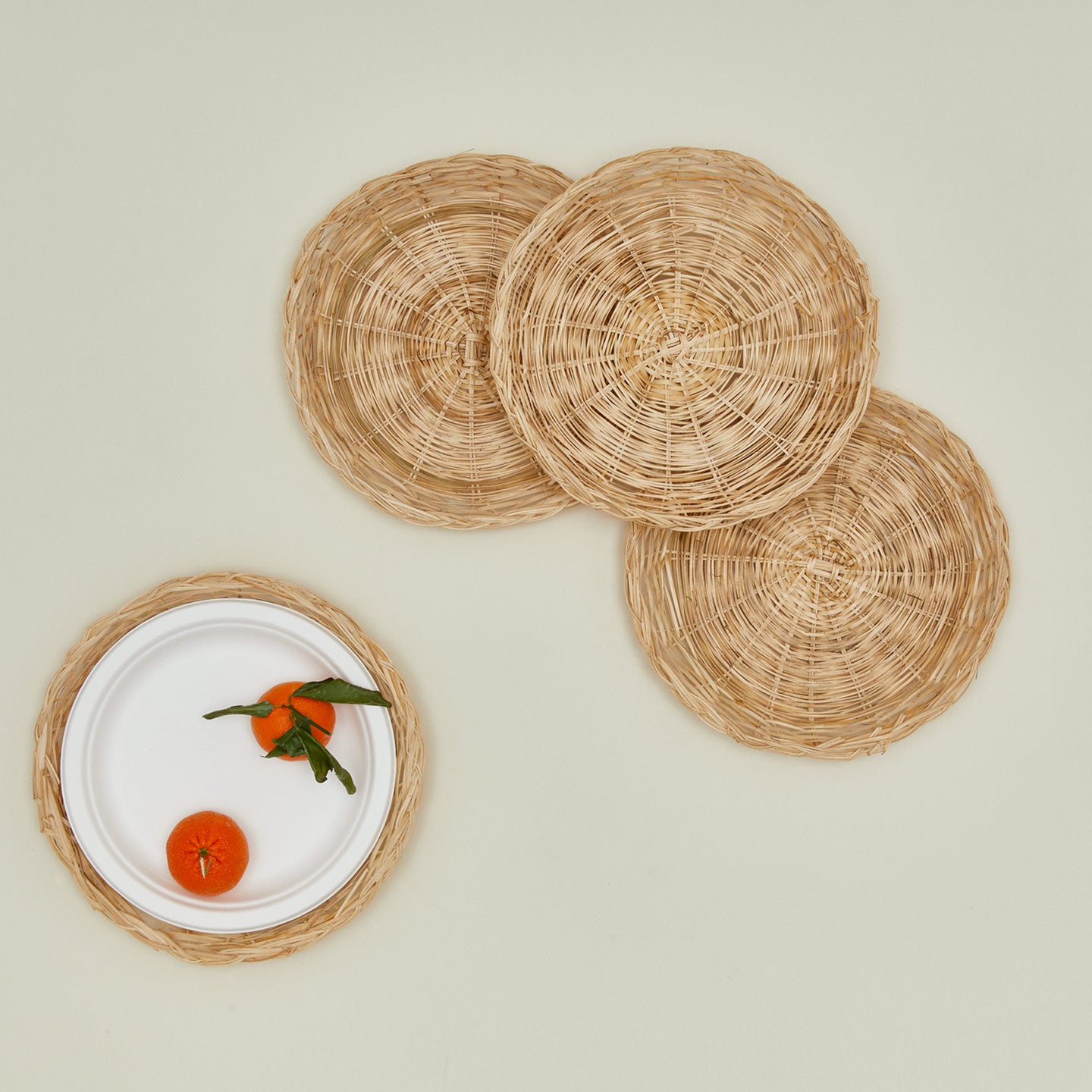 Overhead view of bamboo plate holders set of 4 with clementine