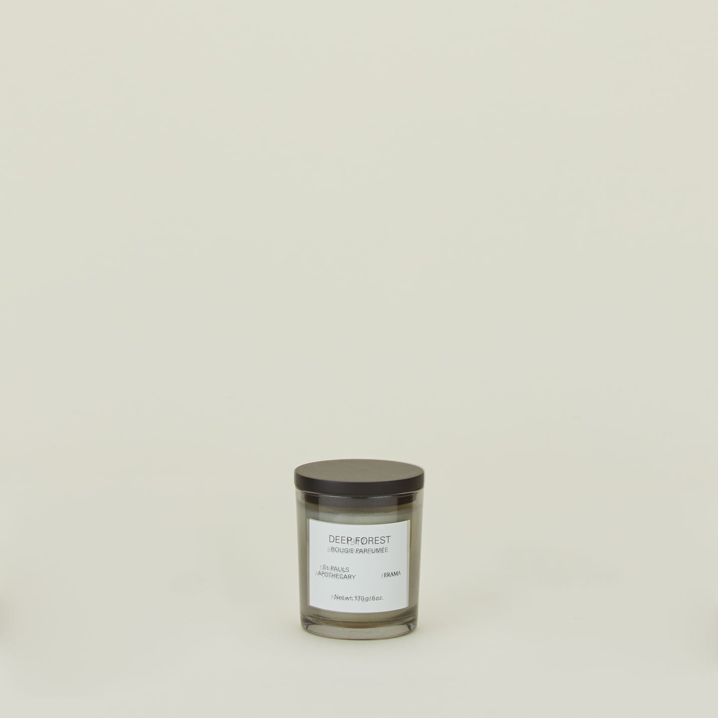 A wax candle with the scent Deep Forest. 