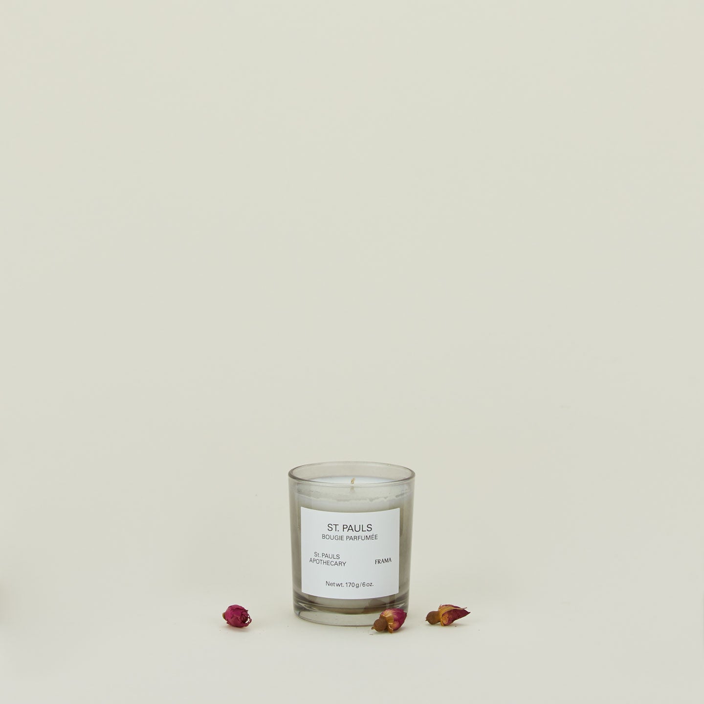 A wax candle with the scent St. Pauls, with dried florals.