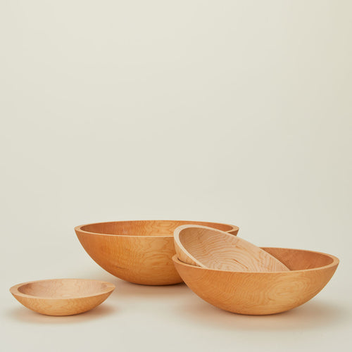 A group of maple wood bowls in four sizes.