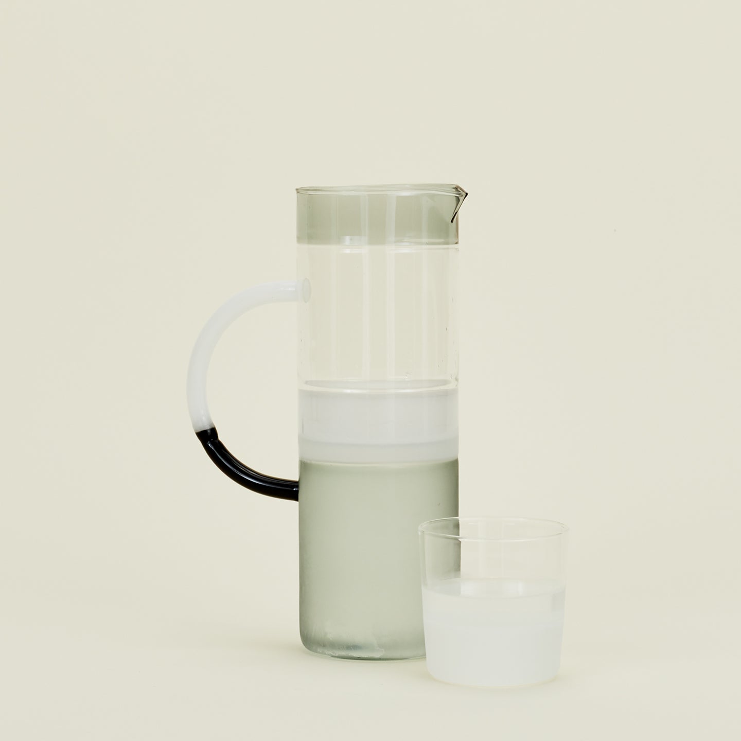 Tequila Sunrise Jug in Smoke along with a drinking glass.