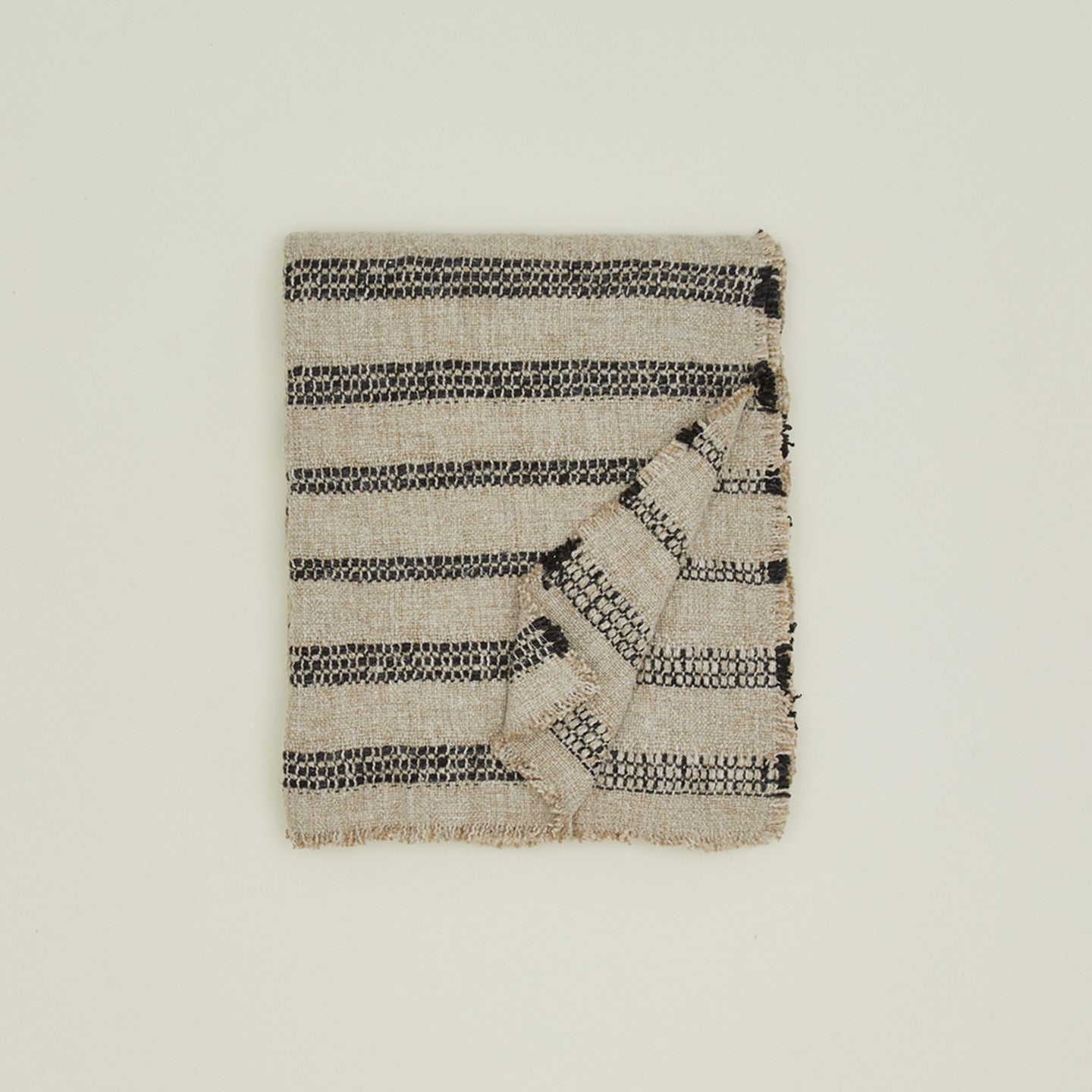 Overhead view of folded tahoe striped throw