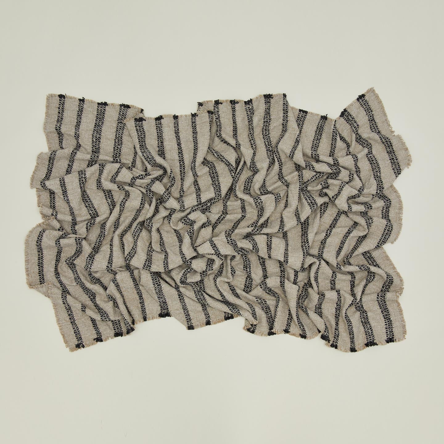 Overhead view of messy tahoe striped throw