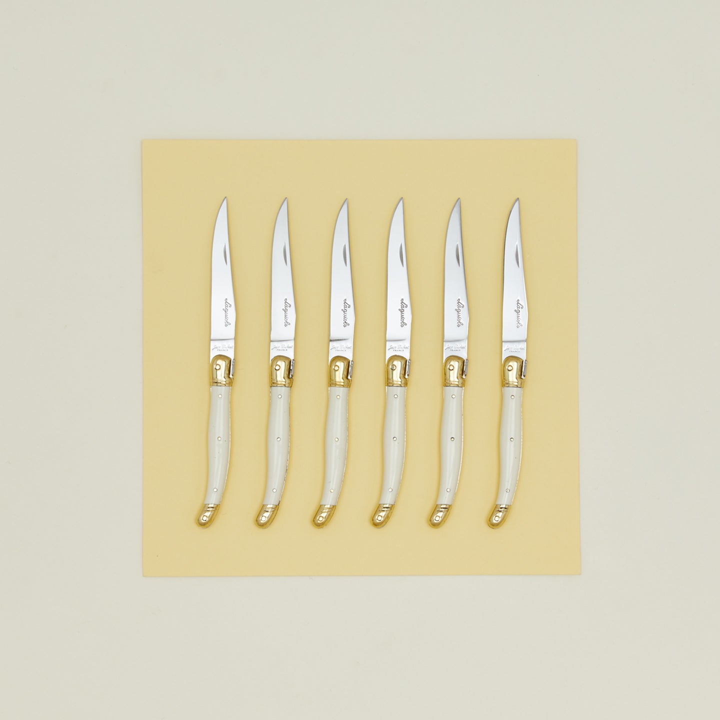 Jean Dubost steak knives set of 6 on yellow paper