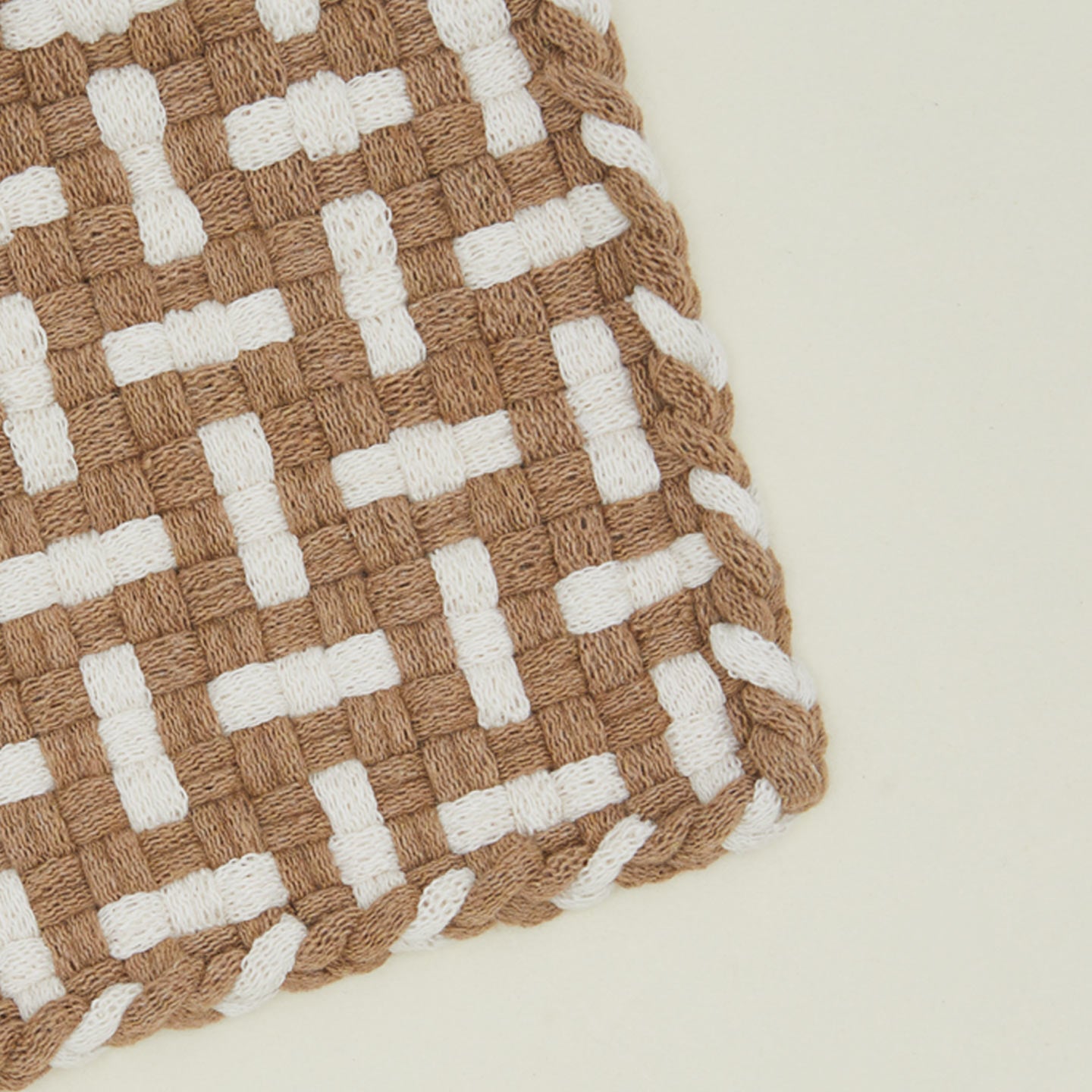 Detail view of parquet potholder in flax and white